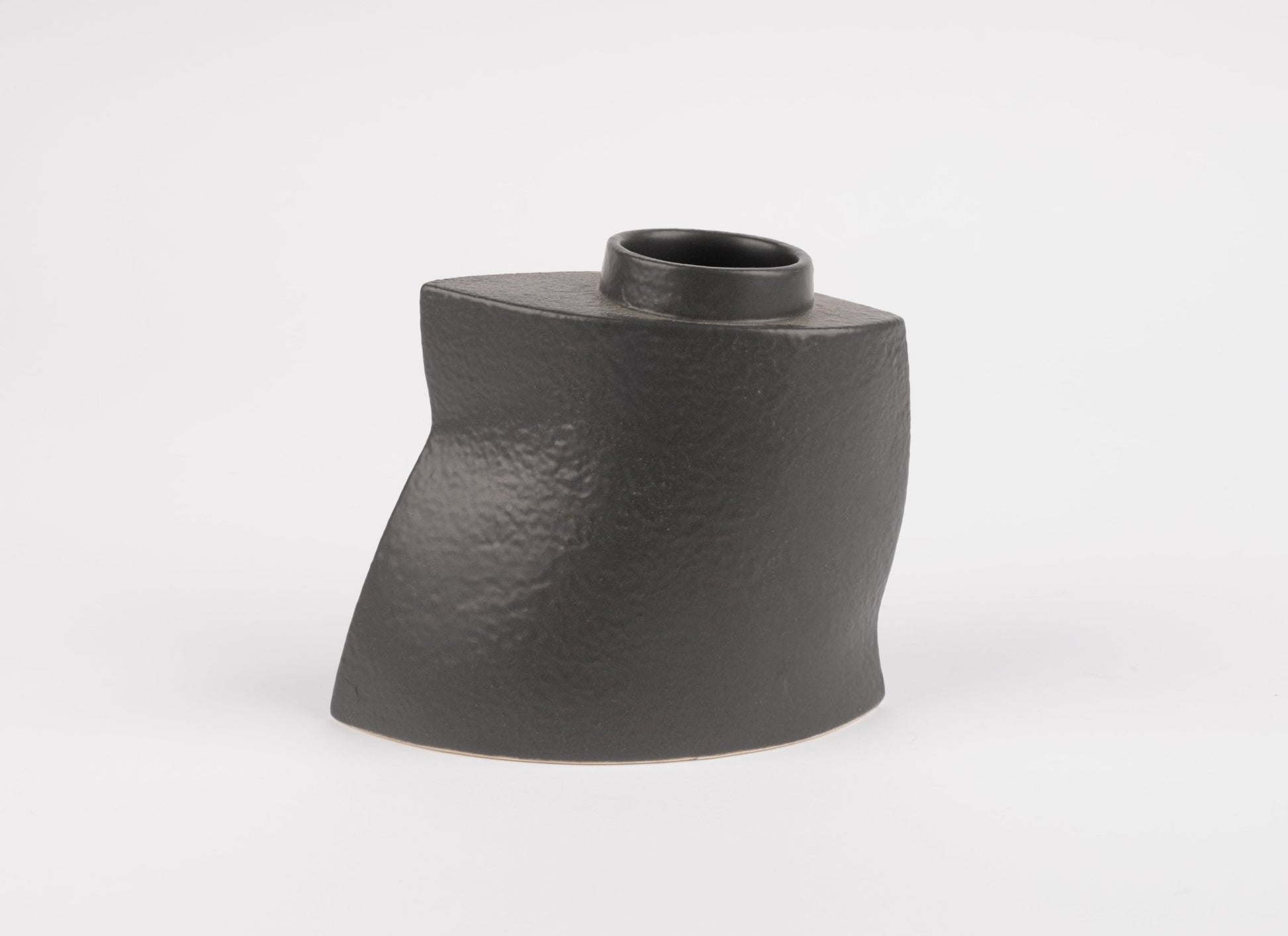 Handcrafted sculptural black stoneware vase with asymmetrical faceted silhouette and matte charcoal finish