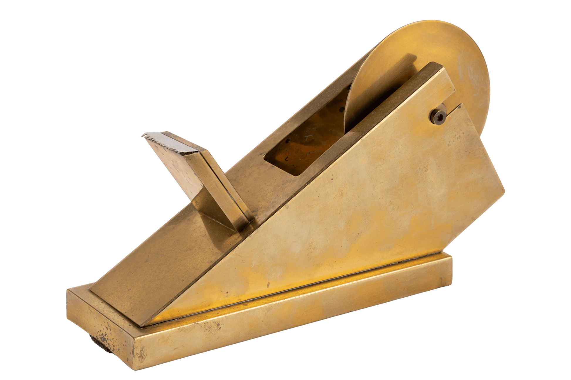 Vintage sculptural brass tape dispenser with minimalist angular form and solid polished finish on white background