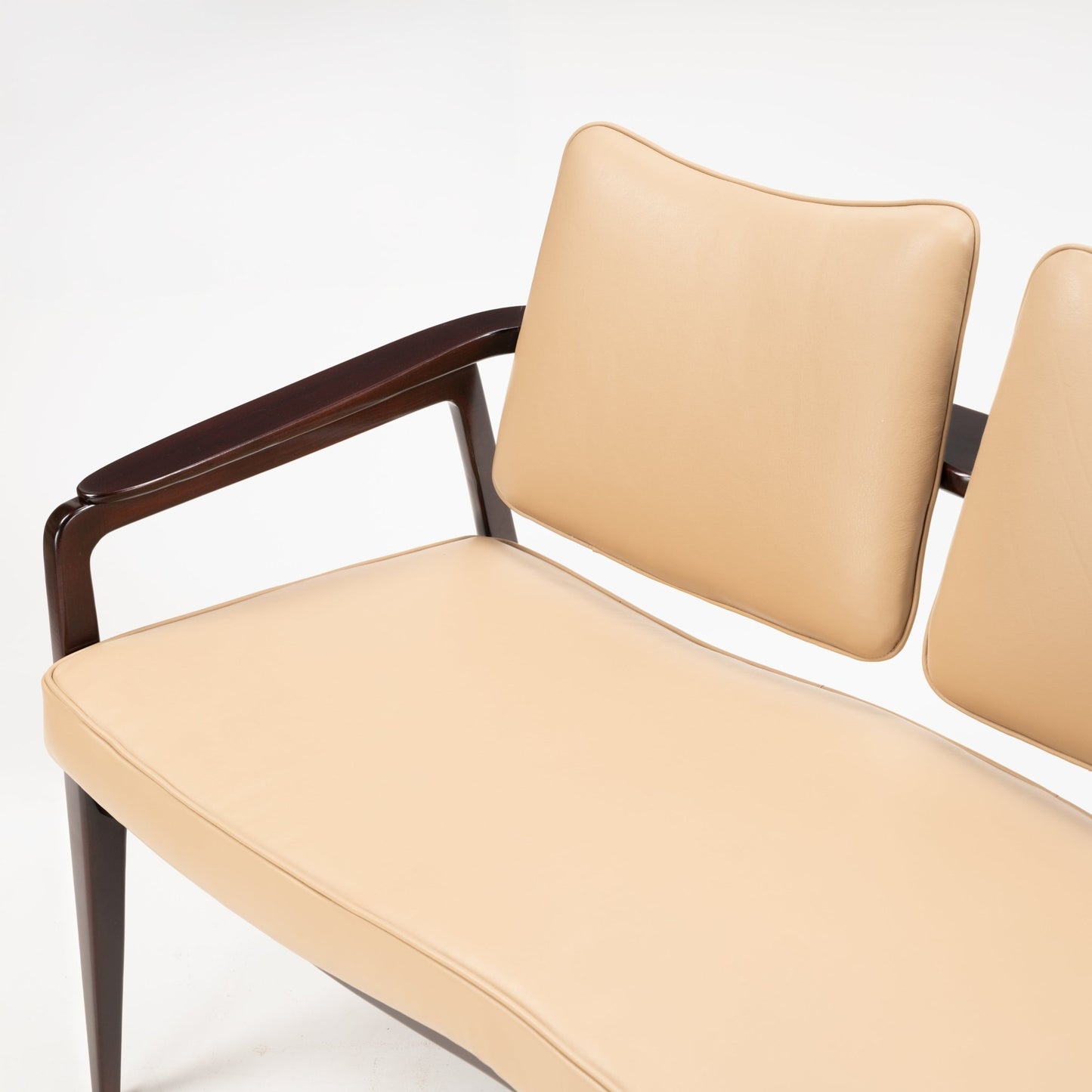 Sigvard Bernadotte Model FD132 Sofa featuring smooth tan leather cushions with a gently curved seat and backrest, supported by a dark wooden frame and angular armrests, exemplifying vintage Danish mid century modern seating design.