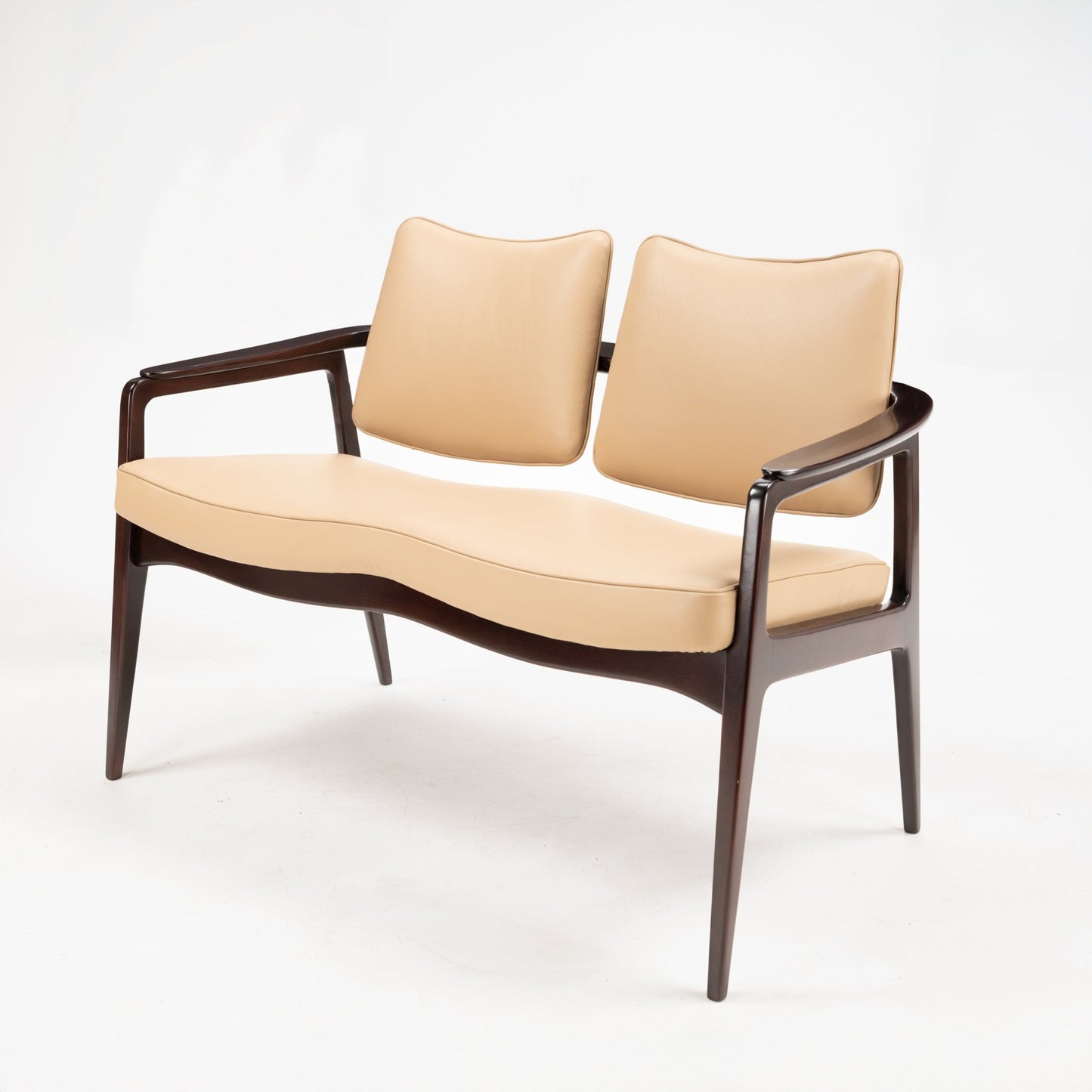 Sigvard Bernadotte Model FD132 Sofa featuring smooth beige leather seats with distinct curved backrests and a sculpted cushion, framed by dark stained wood with gently tapered legs, showcasing mid century modern Danish seating design.