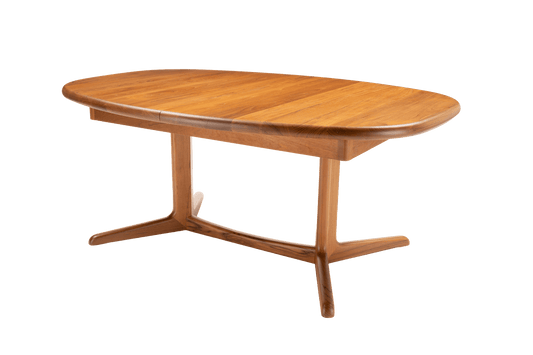 Mid-century modern teak racetrack dining table with rounded edges and central pedestal base on white background.