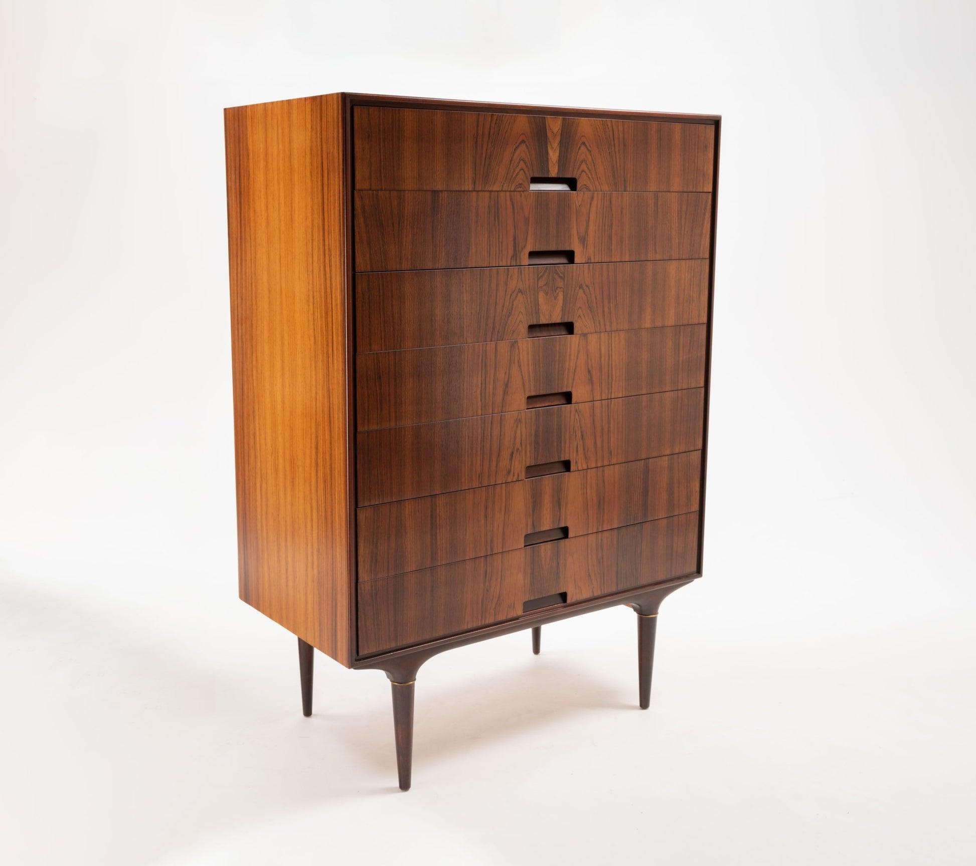 Mid-century modern Svante Skogh rosewood dresser for Seffle with bookmatched panels and brass-accented tapered legs.