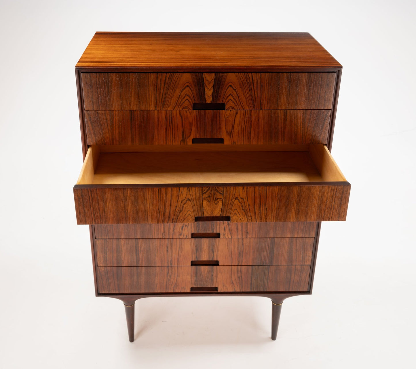 Svante Skogh mid-century modern rosewood dresser with bookmatched panels and brass-tipped legs, one drawer open