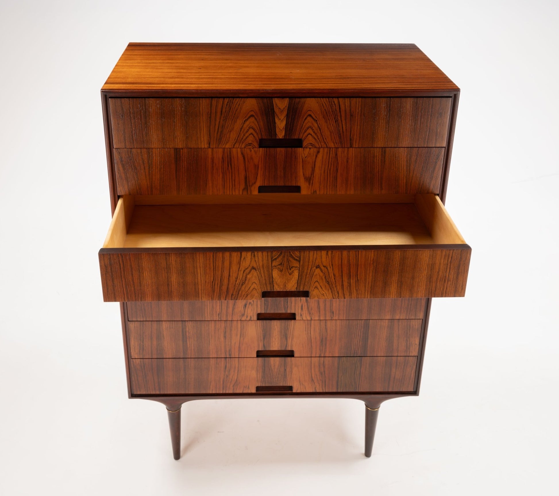 Svante Skogh mid-century modern rosewood dresser with bookmatched panels and brass-tipped legs, one drawer open