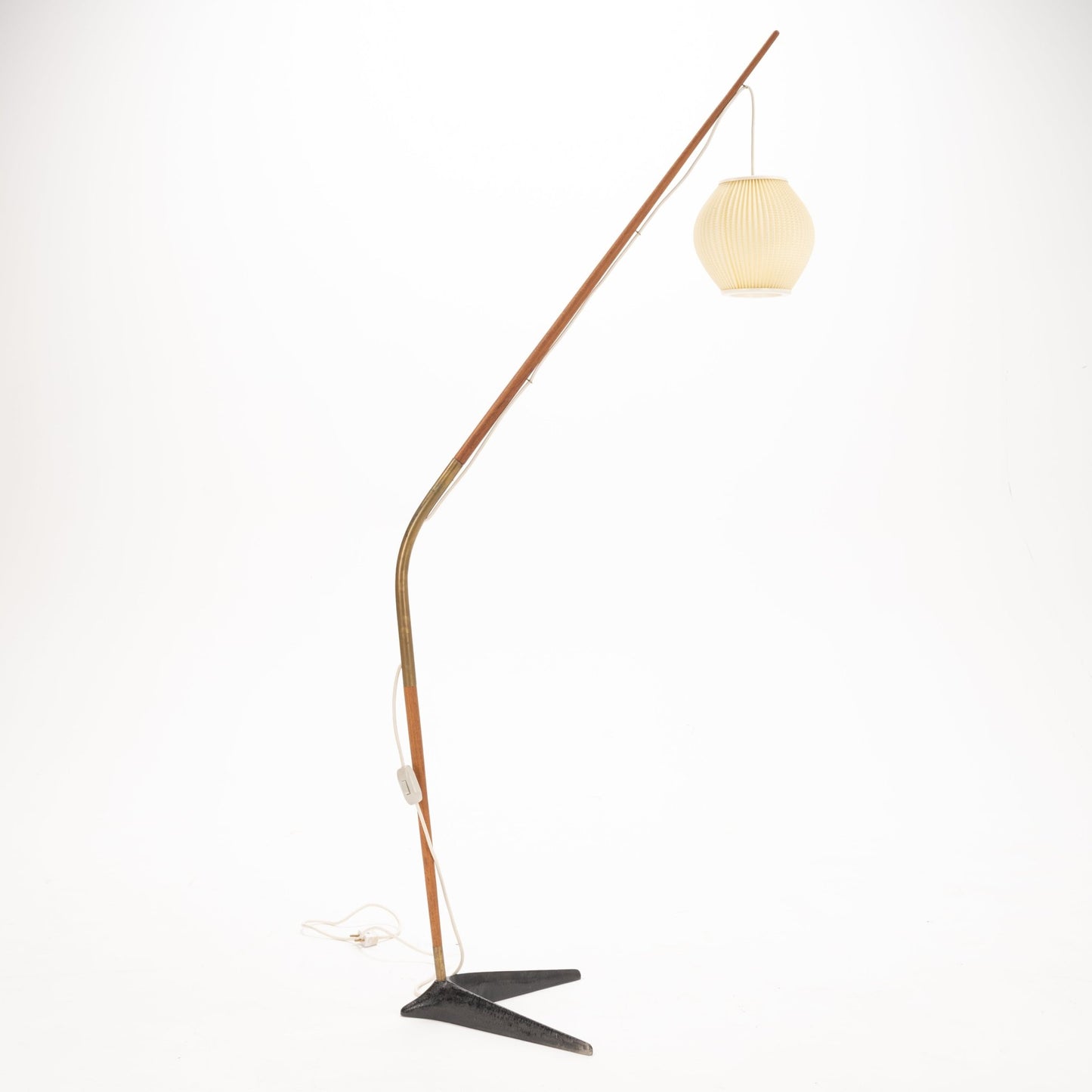 Svend Aage Holm Sorensen Floor Lamp with a slender wooden arm and brass detailing, extending in a fishing pole style to hold a pleated cream lantern shade over a minimalist black metal base, reflecting vintage Danish mid century modern lighting design.
