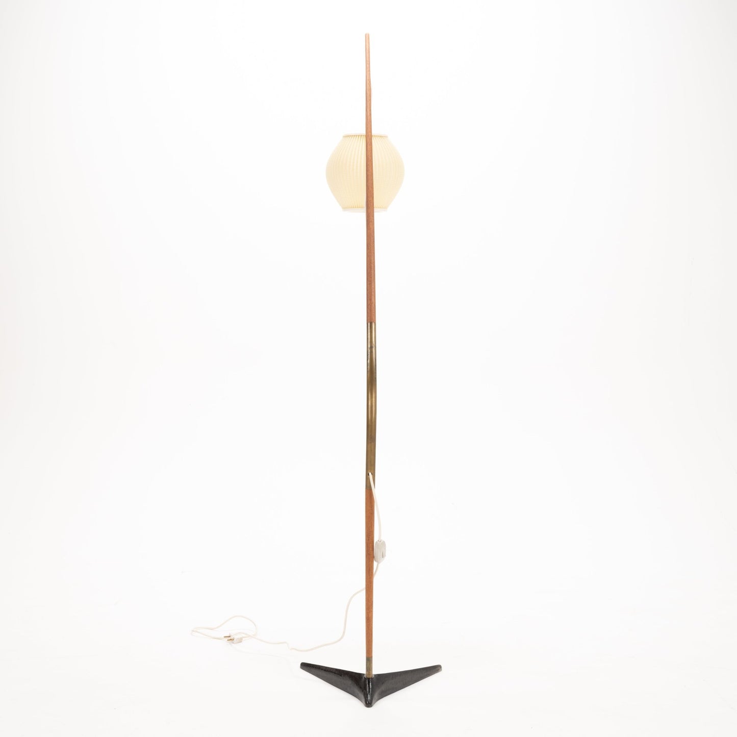 Svend Aage Holm Sorensen Floor Lamp featuring a tall, slender wooden arm with a brass accent, supporting a softly ribbed cream paper lantern shade above a black triangular metal base, embodying vintage Danish mid century modern lighting and decorative design.