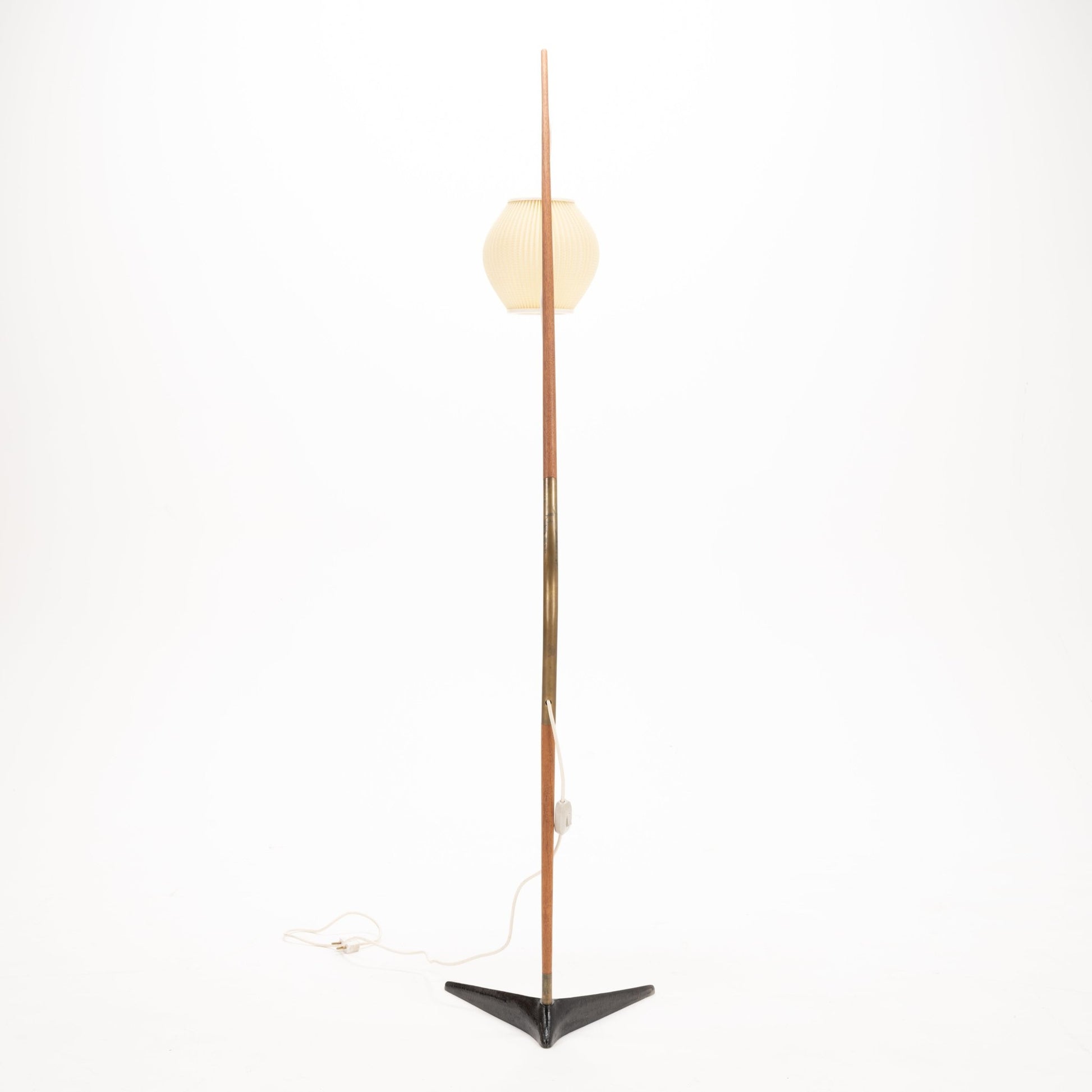 Svend Aage Holm Sorensen Floor Lamp featuring a tall, slender wooden arm with a brass accent, supporting a softly ribbed cream paper lantern shade above a black triangular metal base, embodying vintage Danish mid century modern lighting and decorative design.