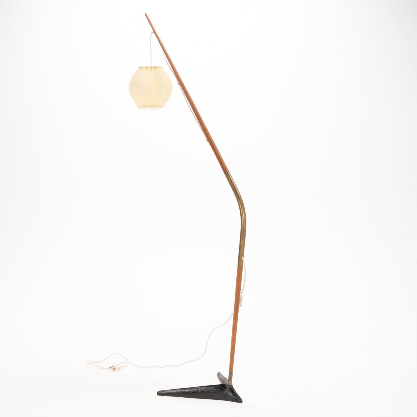 Svend Aage Holm Sorensen Floor Lamp with a slender wooden arm arching in a fishing pole style, supporting a pleated cream paper lantern shade and resting on a triangular black metal base, embodying vintage mid century modern lighting and decorative design.