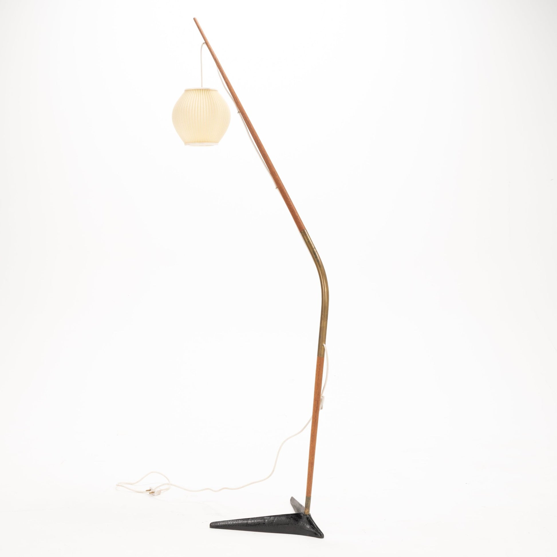 Svend Aage Holm Sorensen Floor Lamp with a slender wooden arm arching in a fishing pole style, supporting a pleated cream paper lantern shade and resting on a triangular black metal base, embodying vintage mid century modern lighting and decorative design.