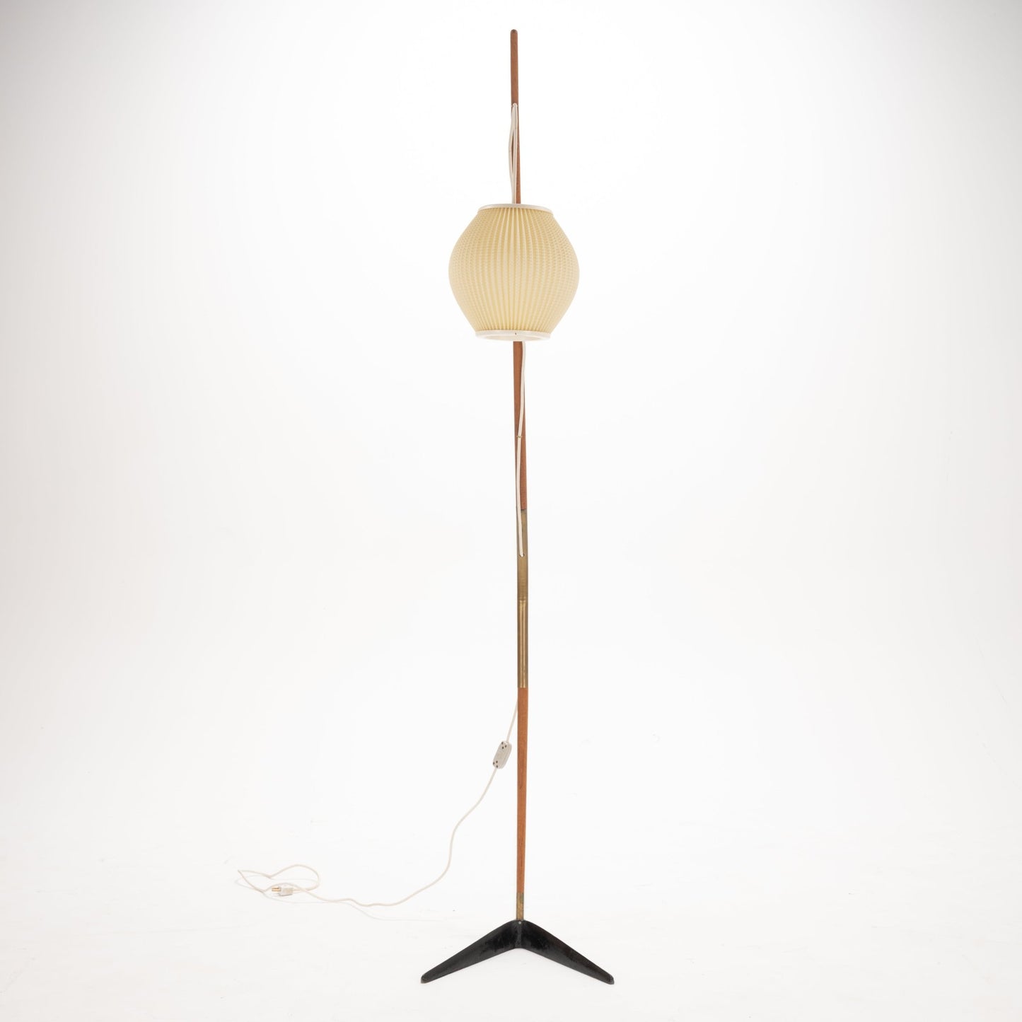 Svend Aage Holm Sorensen Floor Lamp with a tall, slender wooden pole and brass details, featuring a softly ribbed cream paper lantern shade and resting on a minimalist black metal tripod base, reflecting vintage Danish mid century modern lighting design.