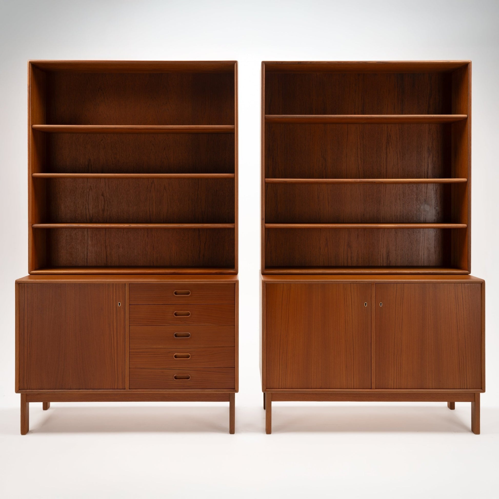 Swedish Teak Cabinet & Bookcase - Set 1 featuring two warm teak units with open shelving above and closed storage with drawers and doors below, showcasing elegant mid century modern storage design.