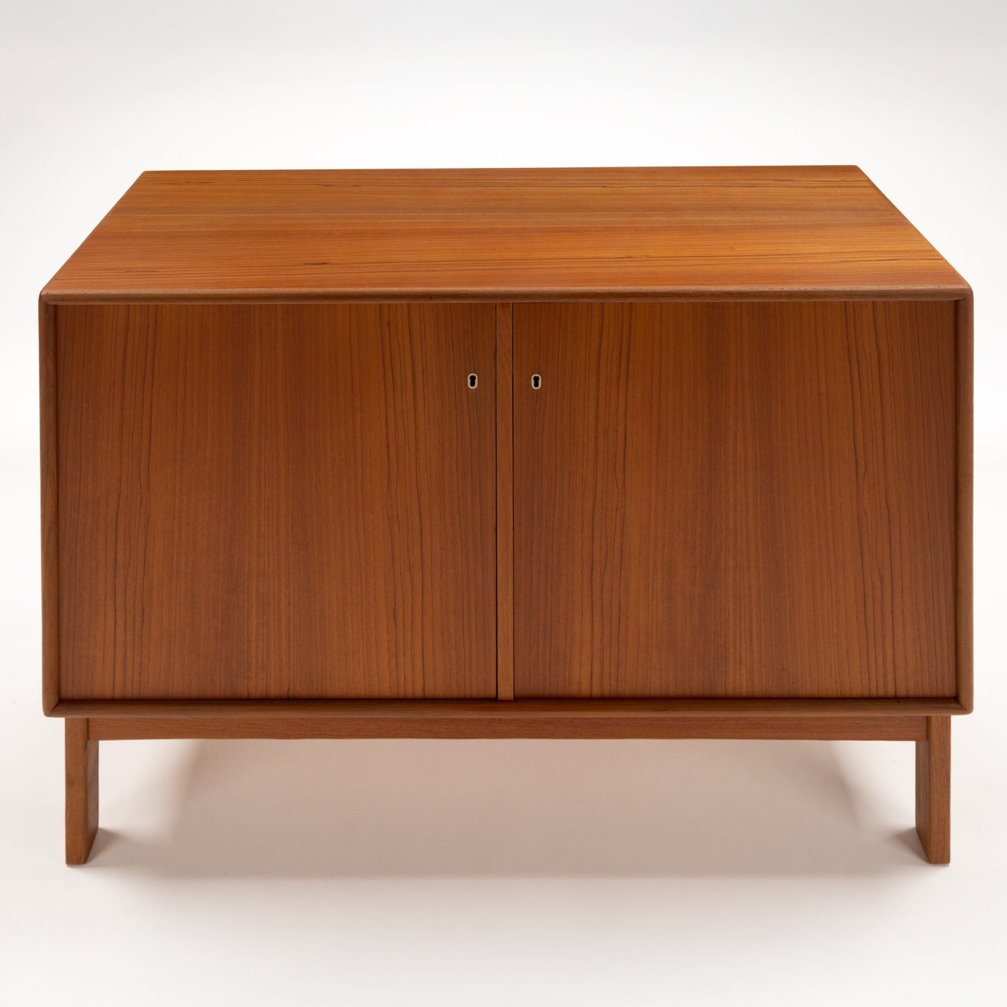 Swedish Teak Cabinet & Bookcase - Set 1 featuring a compact teak storage unit with clean lines, smooth finish, and double doors, reflecting mid century modern furniture design.
