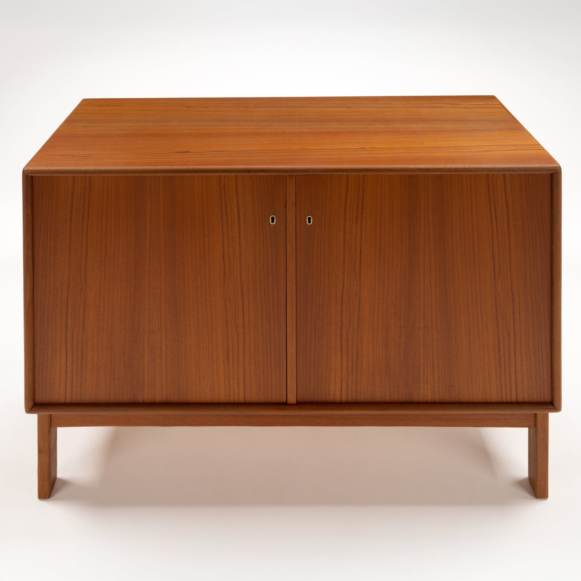 Swedish Teak Cabinet & Bookcase - Set 1 featuring a compact teak storage unit with clean lines, smooth finish, and double doors, reflecting mid century modern furniture design.