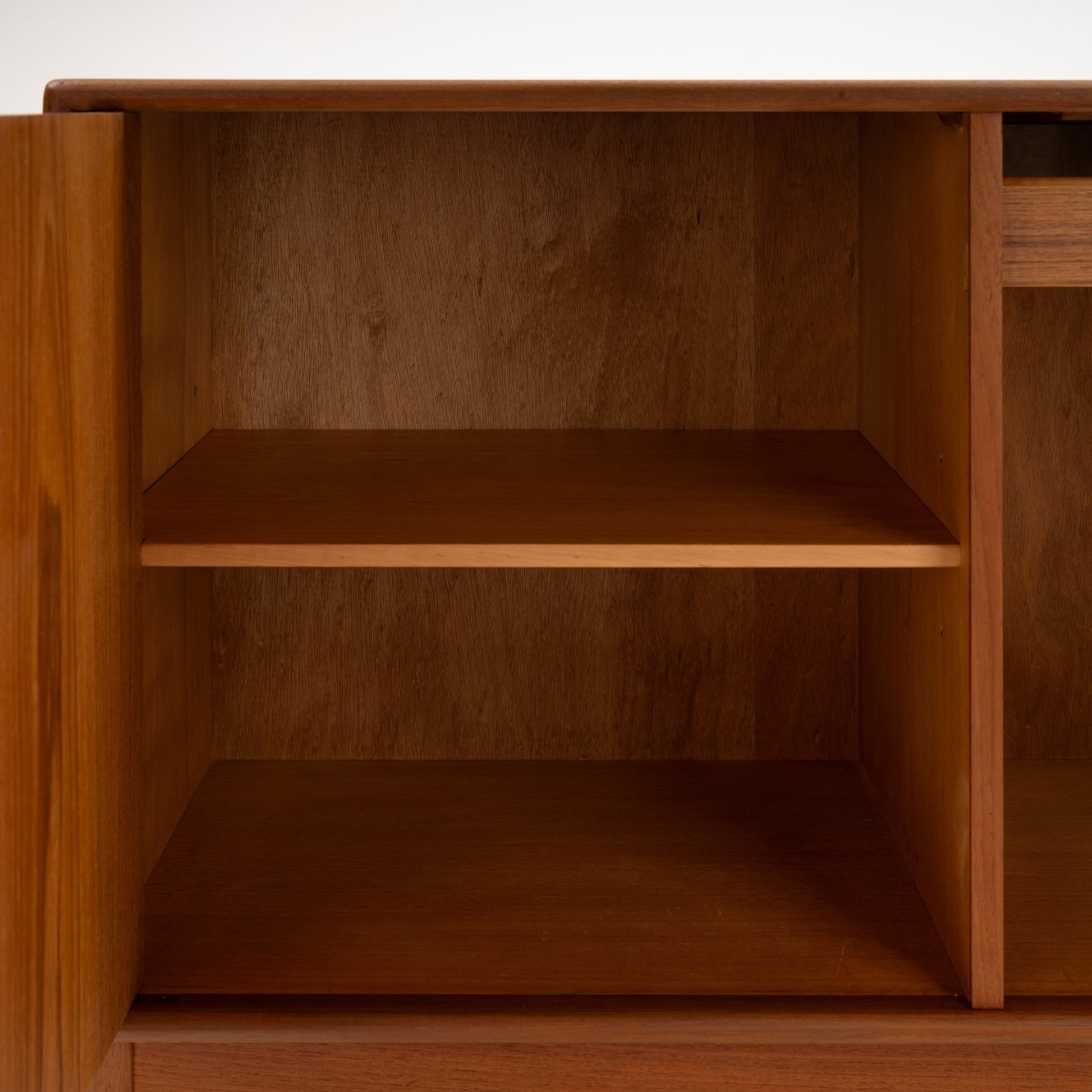 Swedish Teak Cabinet & Bookcase - Set 1 featuring an open cabinet door revealing a spacious interior compartment with a solid wood shelf, highlighting classic mid century modern storage craftsmanship.