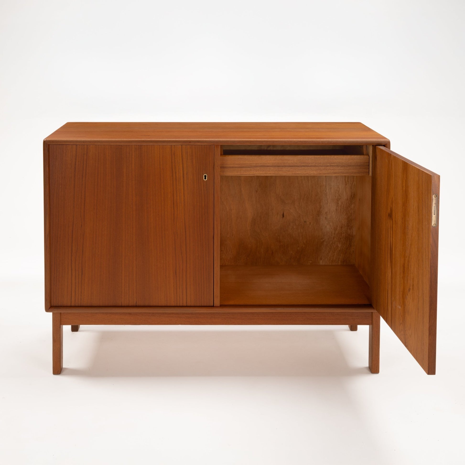 Swedish Teak Cabinet & Bookcase - Set 1 featuring a compact teak unit with one door open to reveal ample storage space and a smooth wood finish, embodying mid century modern design.