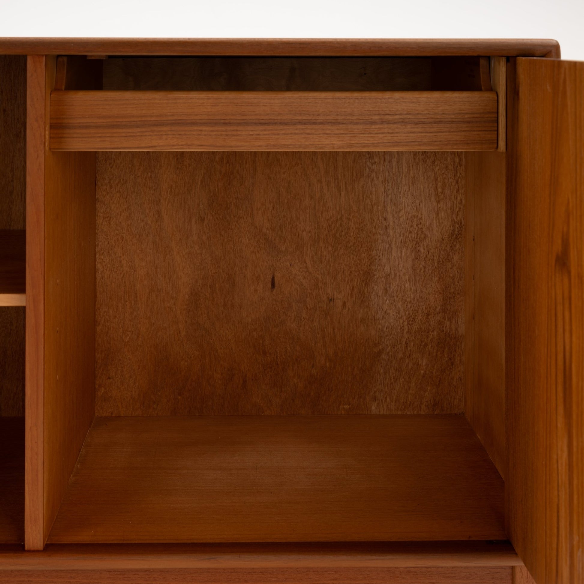 Swedish Teak Cabinet & Bookcase - Set 1 featuring an open storage compartment with a slim drawer above, showcasing warm teak wood and minimalist mid century modern design.