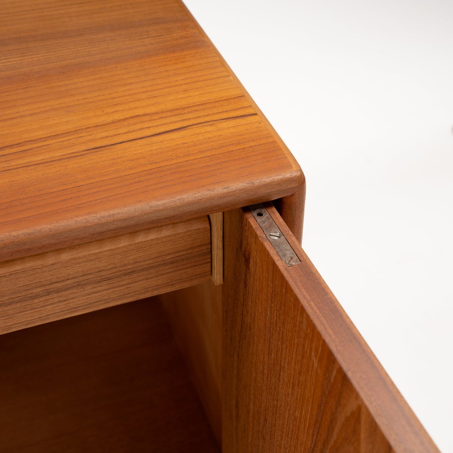 Swedish Teak Cabinet & Bookcase - Set 1 showcasing a smooth teak wood surface with rounded edges and an open door revealing finely crafted wood joinery and minimalist mid century modern style.