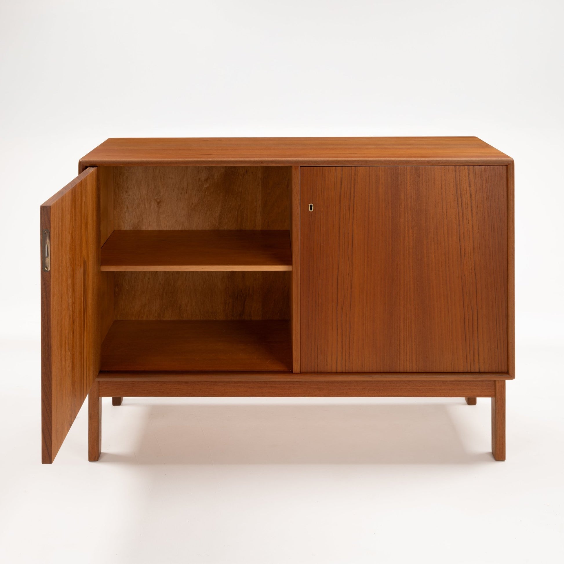Swedish Teak Cabinet & Bookcase - Set 1 featuring a compact storage unit with warm teak wood, an open door revealing two spacious shelves, and sleek minimalist mid century modern design.