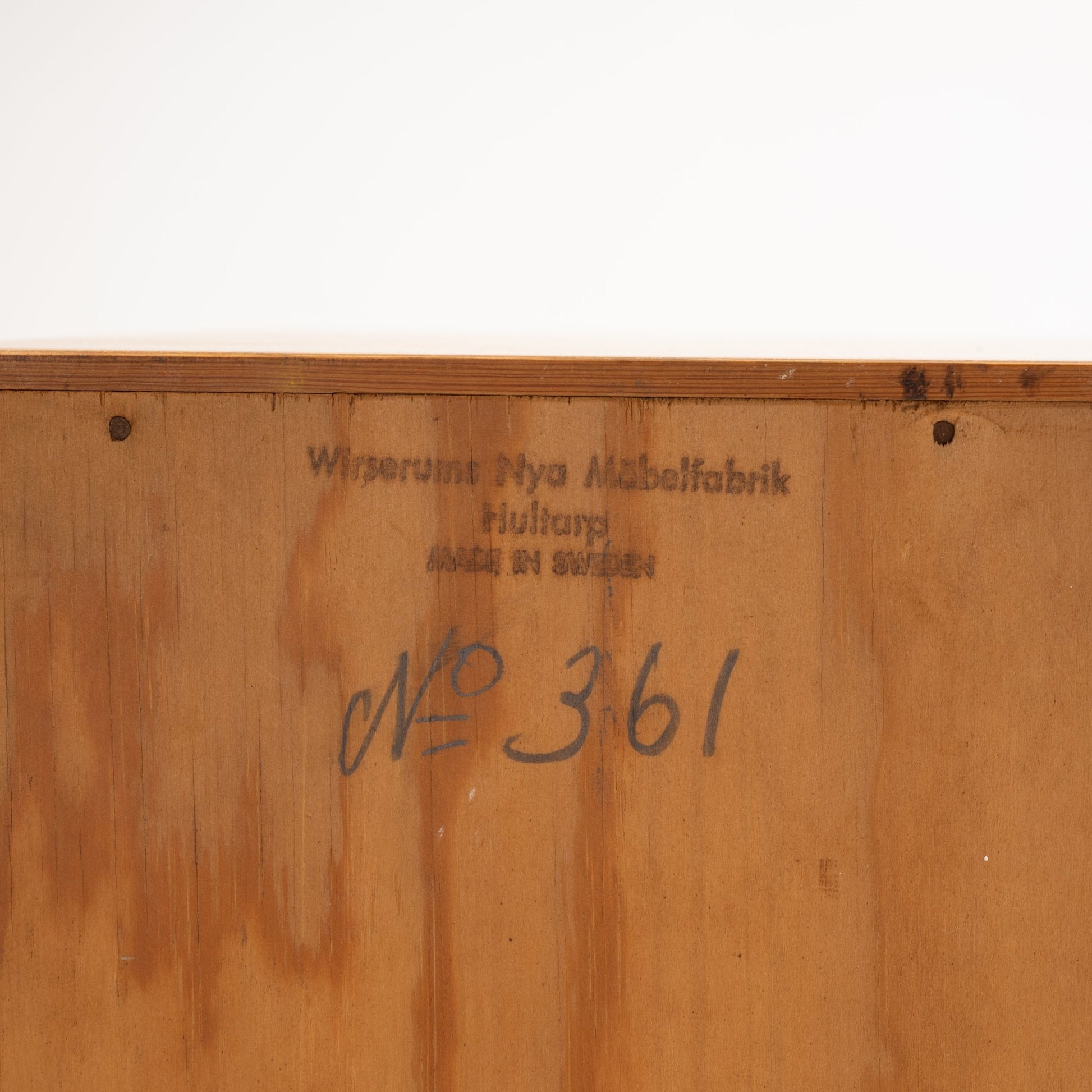 Swedish Teak Cabinet & Bookcase - Set 1 showing the inside of a drawer with vintage manufacturer’s stamp and handwritten model number on smooth wood surface, highlighting mid century modern craftsmanship.