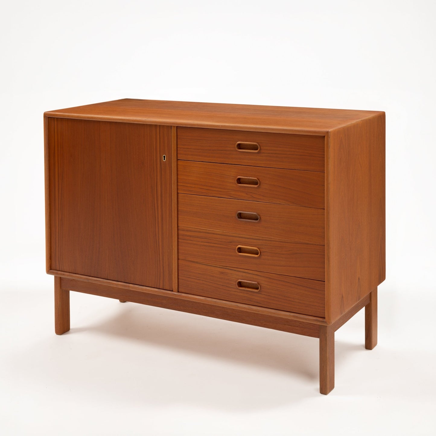 Swedish Teak Cabinet & Bookcase - Set 2 featuring a compact storage unit with a single door and five drawers, crafted from warm teak wood showcasing mid century modern vintage Danish design.