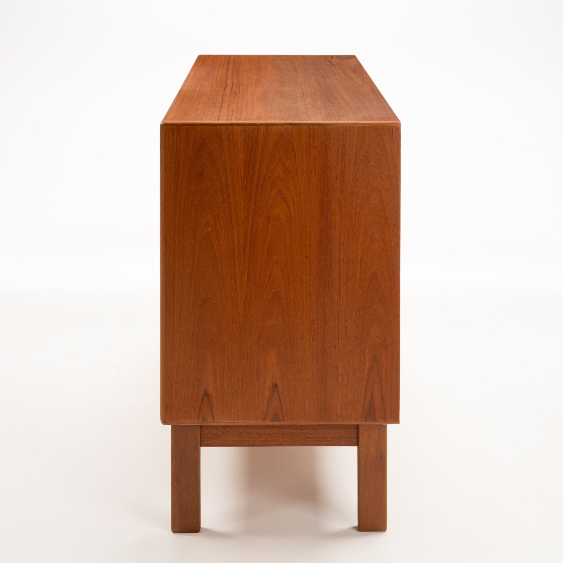 Swedish Teak Cabinet & Bookcase - Set 2 showing the smooth, rich teak wood side panel with subtle grain patterns and clean lines on this vintage mid century modern storage piece.
