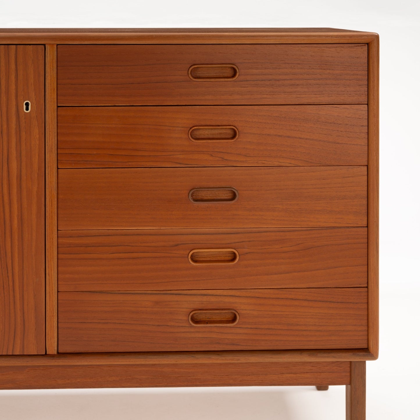 Swedish Teak Cabinet & Bookcase - Set 2 showcasing five spacious drawers with integrated oval handles, crafted from warm teak wood highlighting vintage mid century modern storage and design.