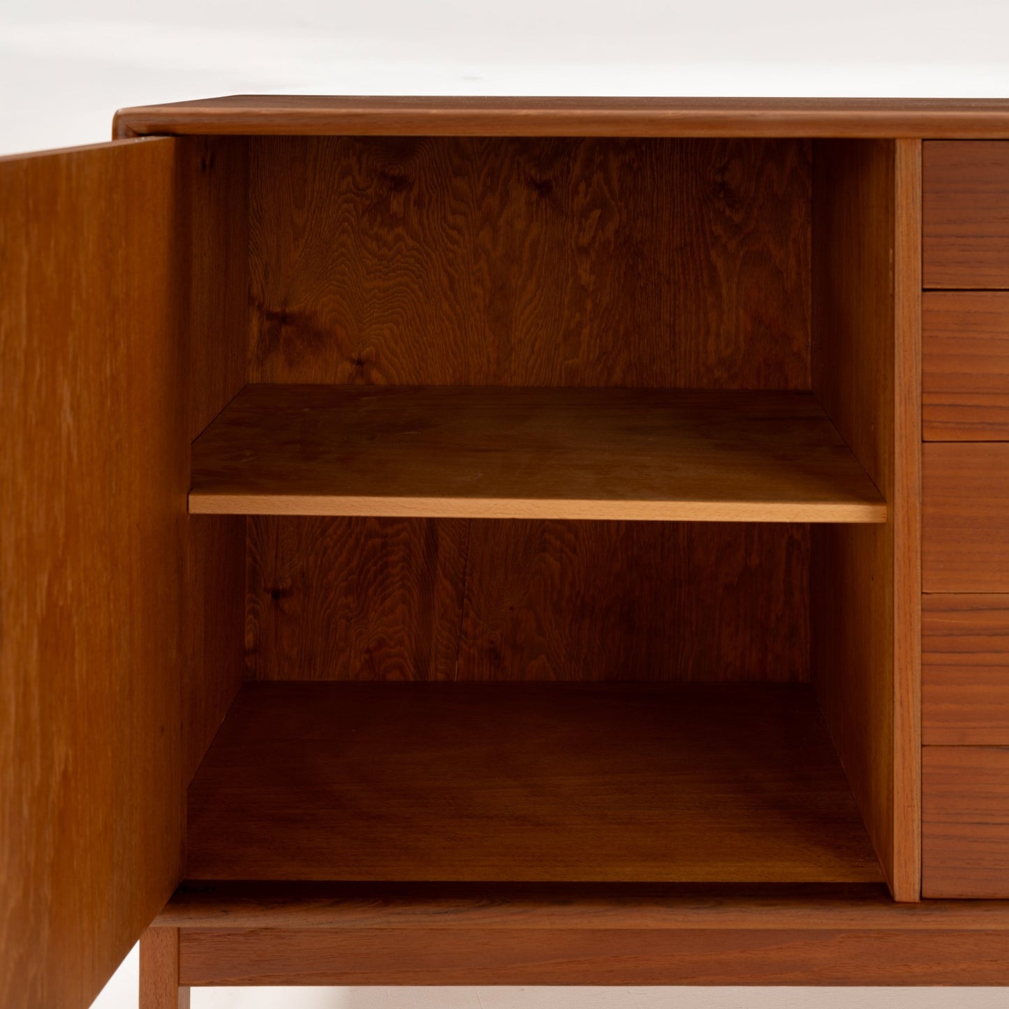 Swedish Teak Cabinet & Bookcase - Set 2 showing an open cabinet compartment with a spacious interior shelf in warm teak wood, highlighting vintage mid century modern storage craftsmanship.