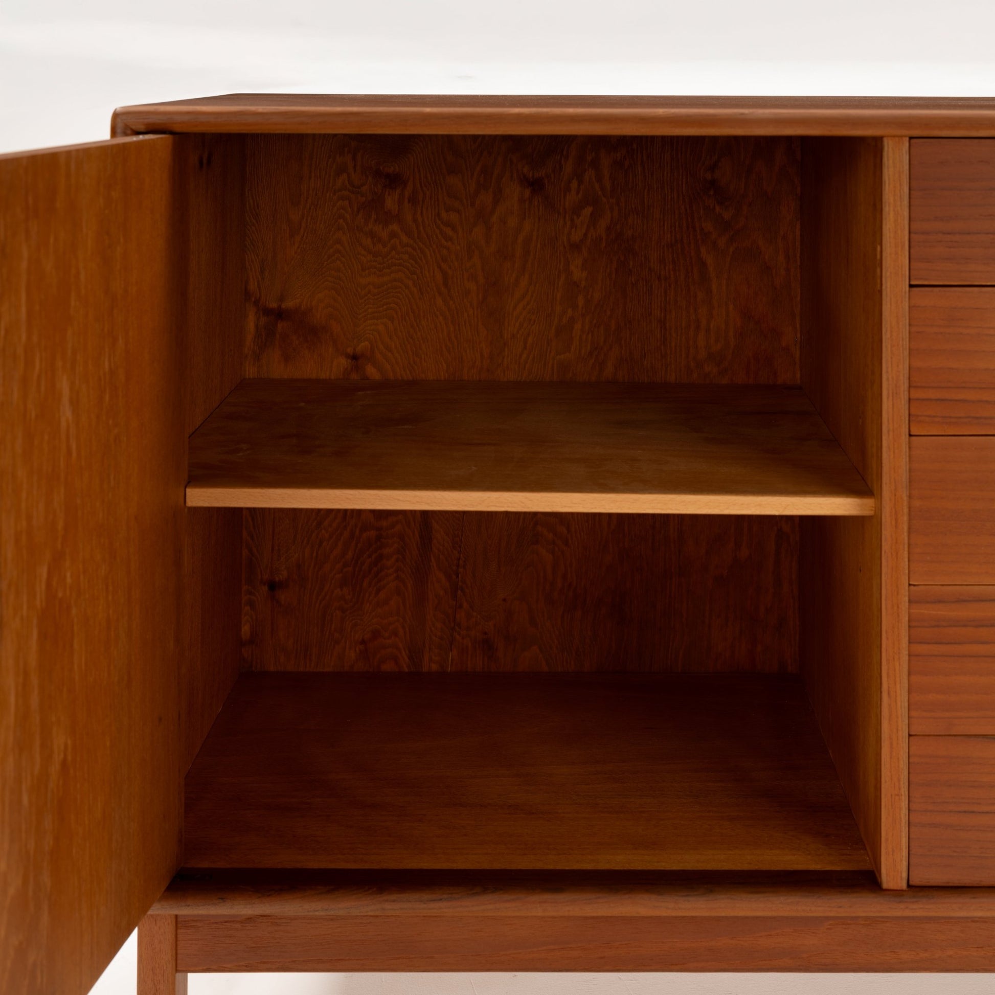 Swedish Teak Cabinet & Bookcase - Set 2 showing an open cabinet compartment with a spacious interior shelf in warm teak wood, highlighting vintage mid century modern storage craftsmanship.