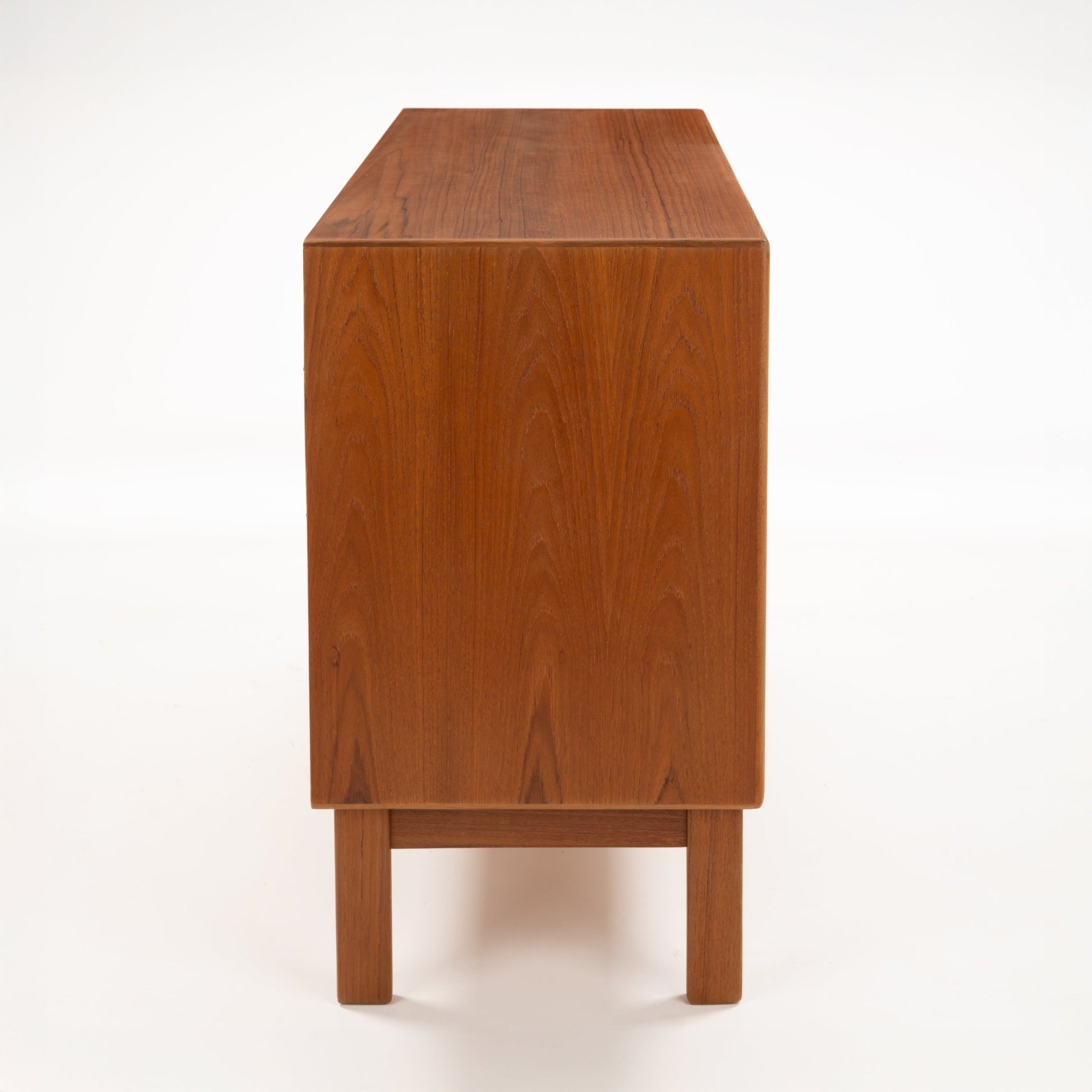Swedish Teak Cabinet & Bookcase - Set 2 showing the smooth teak wood grain and clean, minimalist lines of the side panel on this vintage mid century modern storage piece.