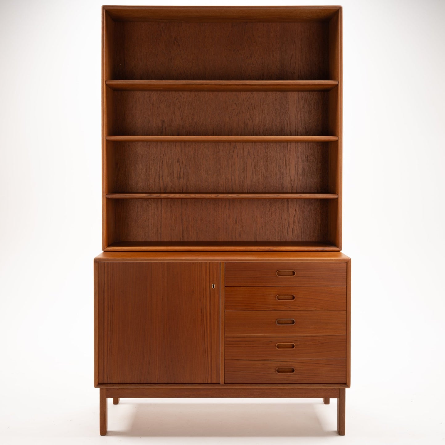 Swedish Teak Cabinet & Bookcase - Set 2 featuring a vintage mid century modern storage unit with open shelving above and a combination of a door and five drawers below in warm teak wood.