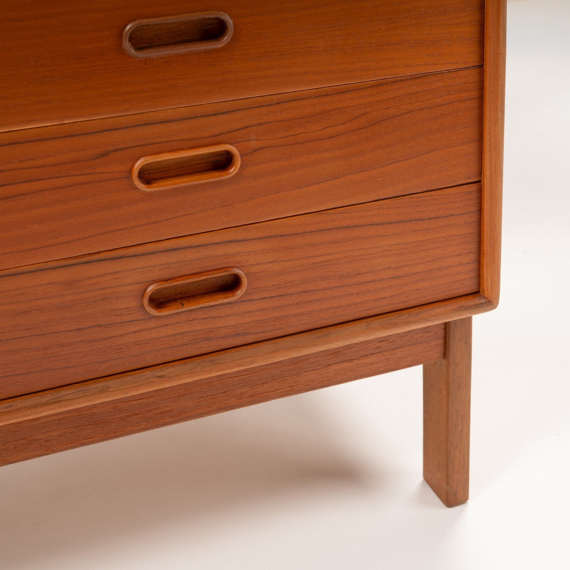 Swedish Teak Cabinet & Bookcase - Set 2 featuring close-up details of three teak drawers with smooth integrated recessed handles, highlighting vintage Danish mid century modern craftsmanship.