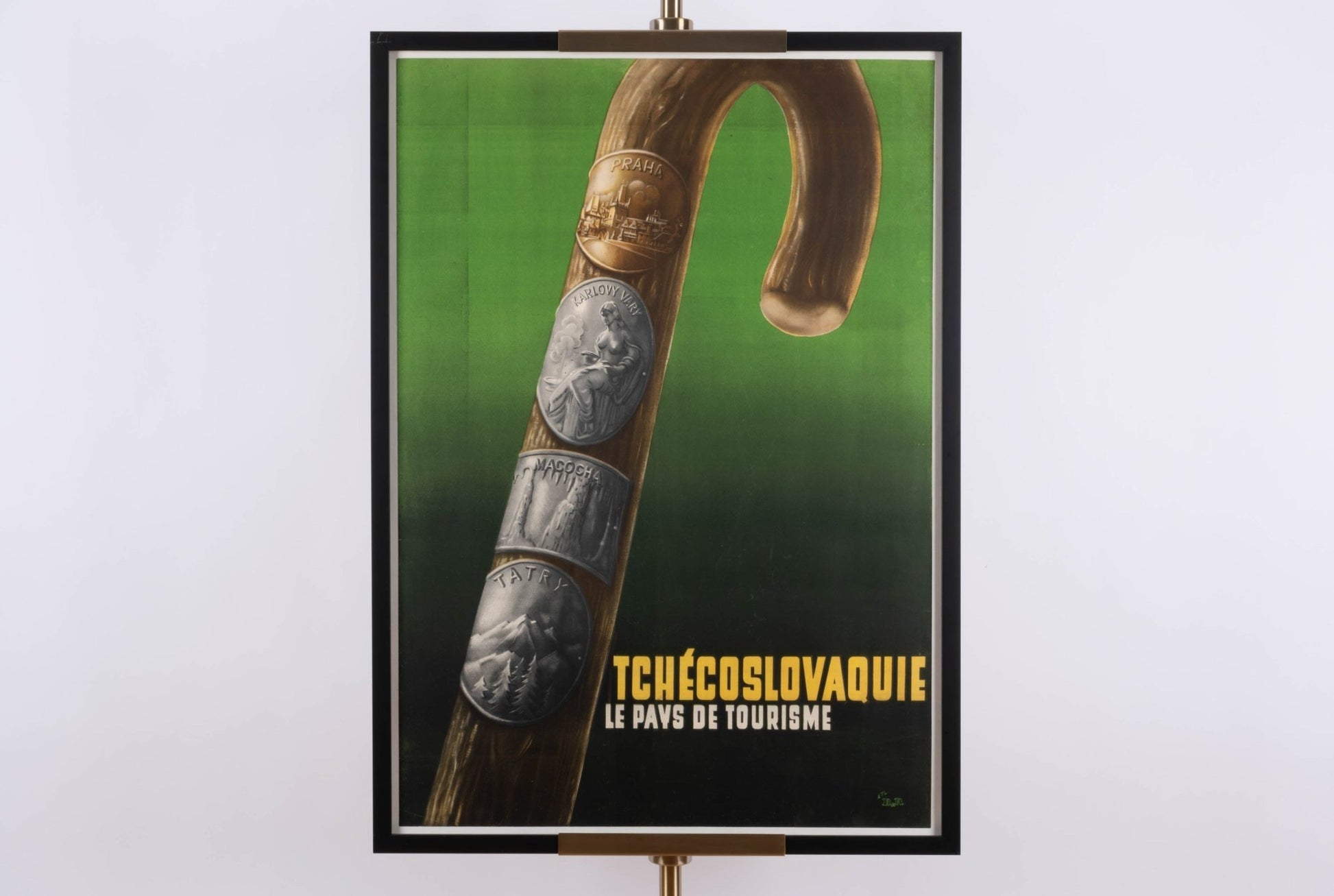 Framed vintage Tchecoslovaquie travel poster with linen backing and detailed walking stick design on green background.