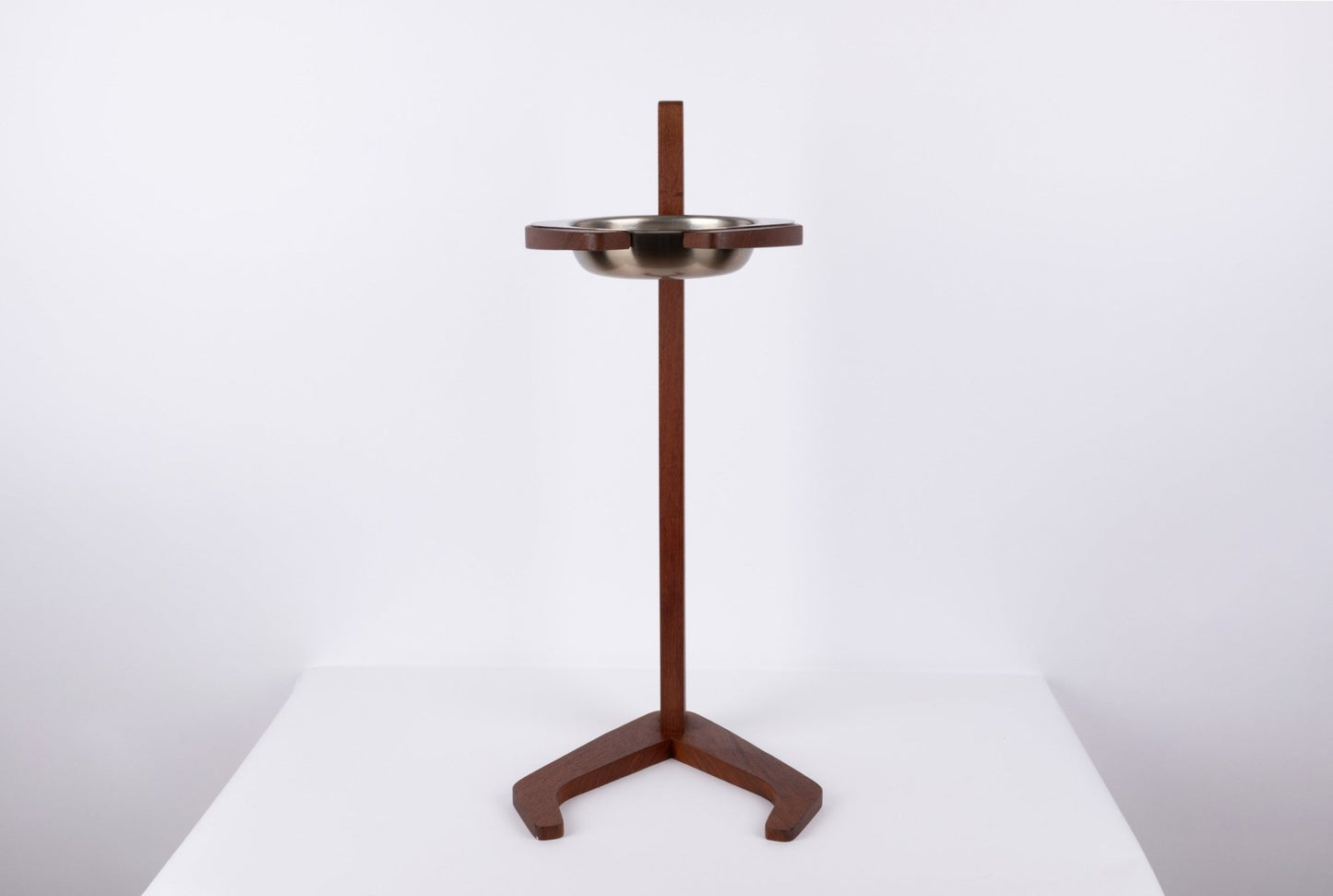 Teak ashtray stand with metal bowl, featuring a tapered stem and stylized tripod base in mid-century modern style.