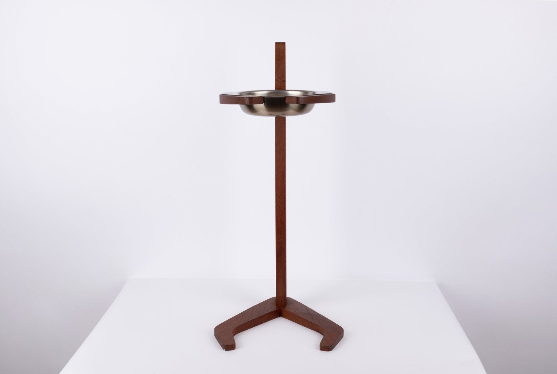 Teak ashtray stand with metal bowl, featuring a tapered stem and stylized tripod base in mid-century modern style.