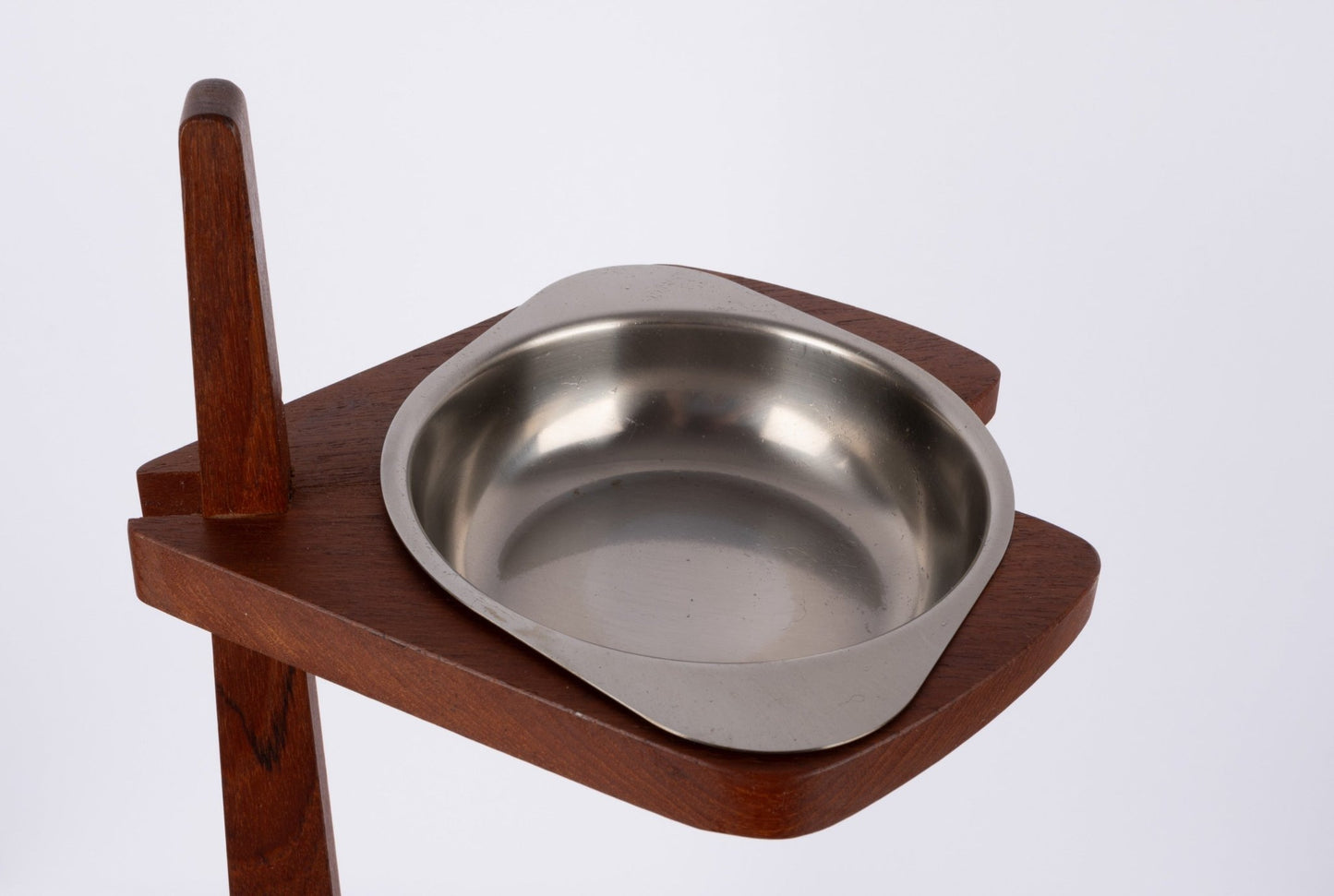 Teak ashtray stand with tapered stem and metal ashtray bowl floating on mid-century modern teak frame