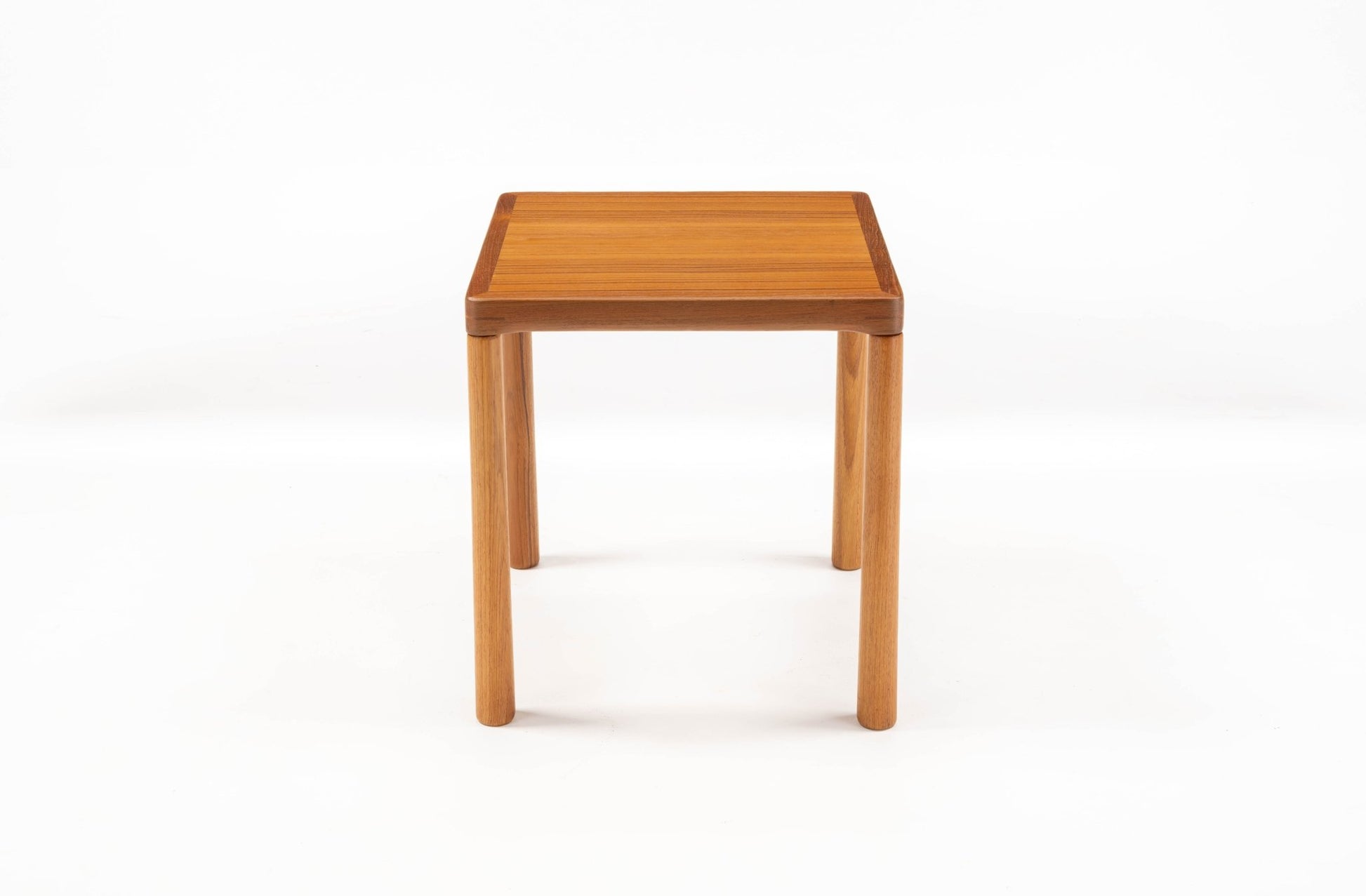 Pair of teak side tables with oak legs and finger joint details on corners, showcasing minimalist Scandinavian design.