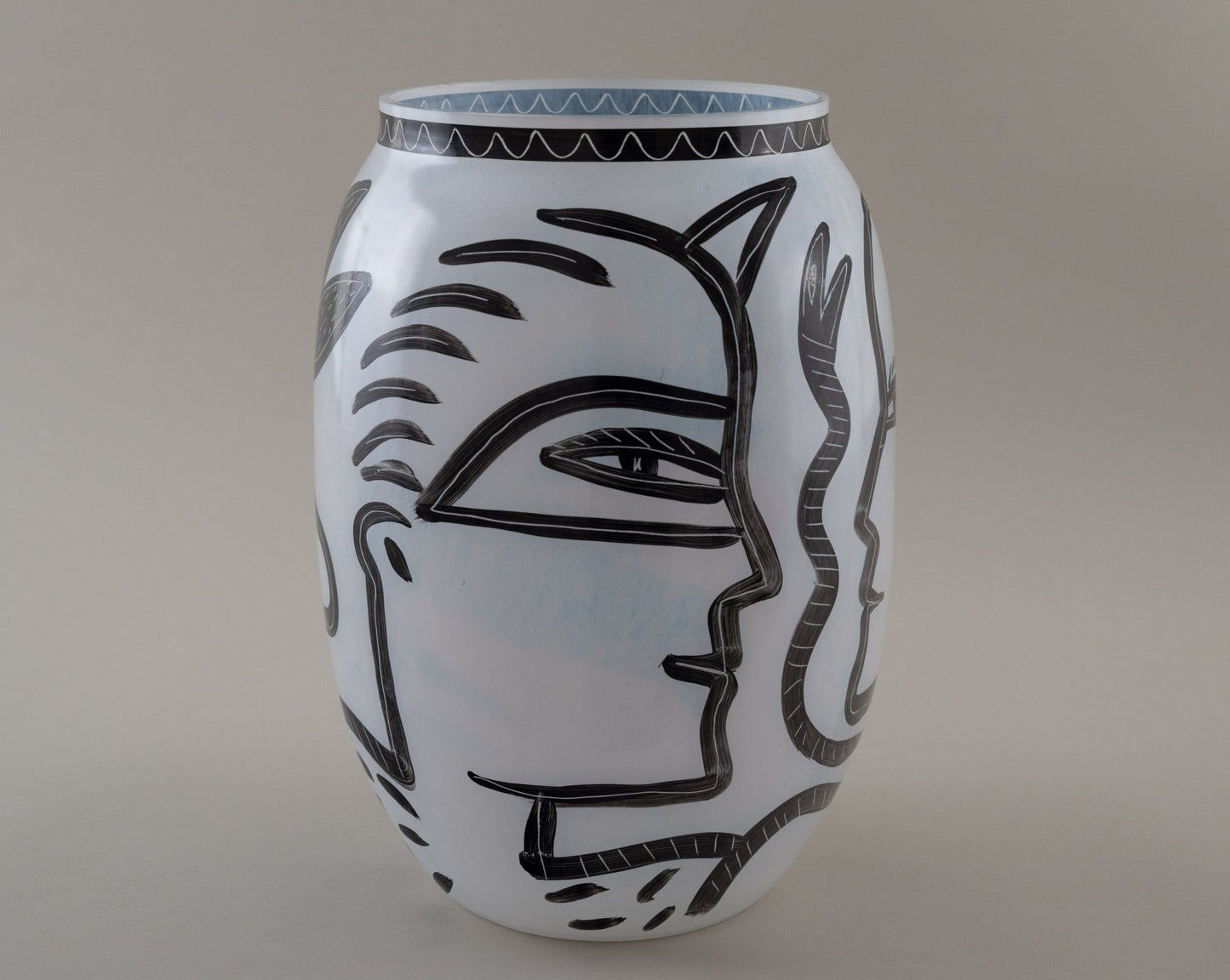 Ulrica Hydman-Vallien "Caramba" vase for Kosta Boda with bold black hand-painted faces and serpent motifs on white glass