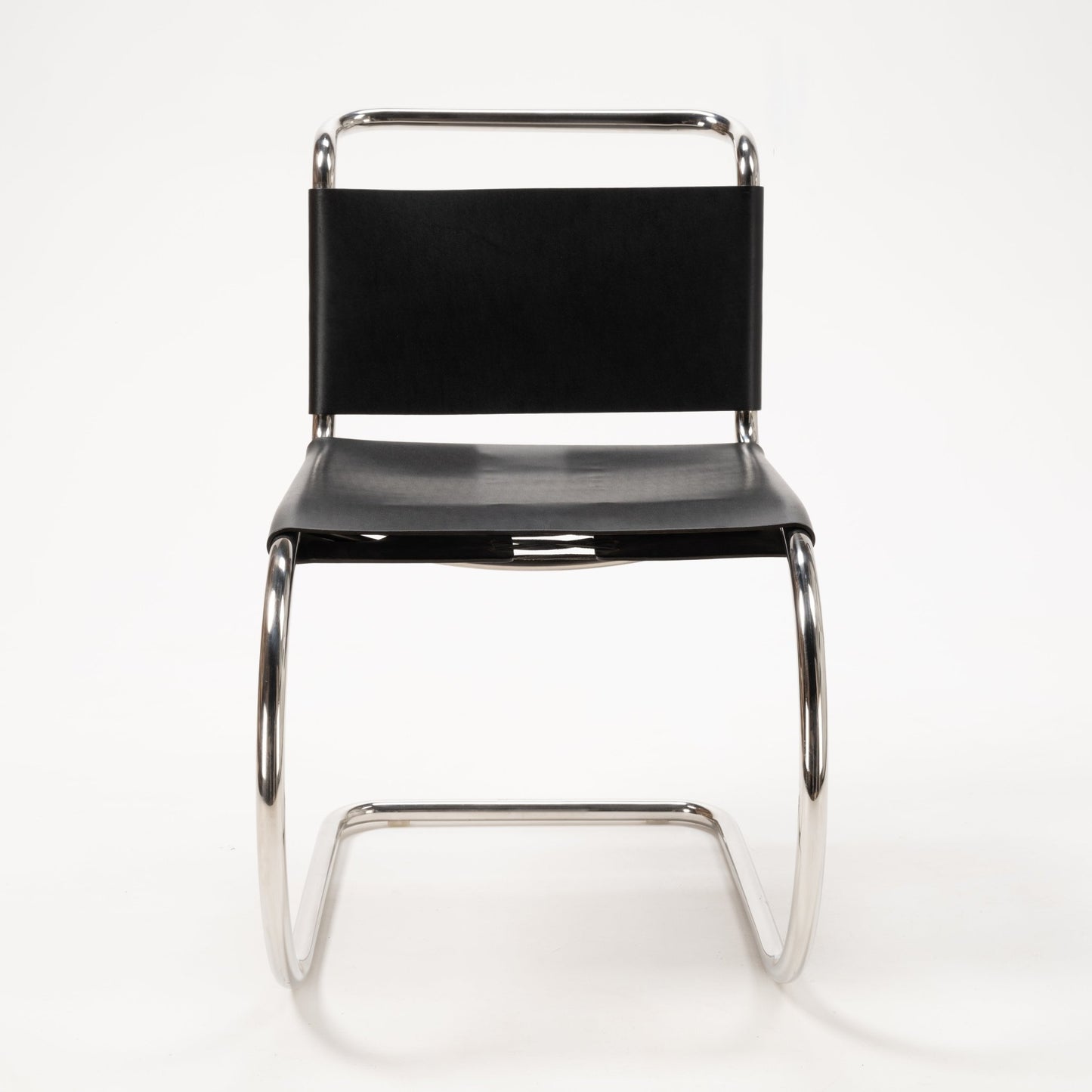 Single Van Der Rohe MR10 cantilever chair featuring polished chrome tubular frame and black leather seat and backrest