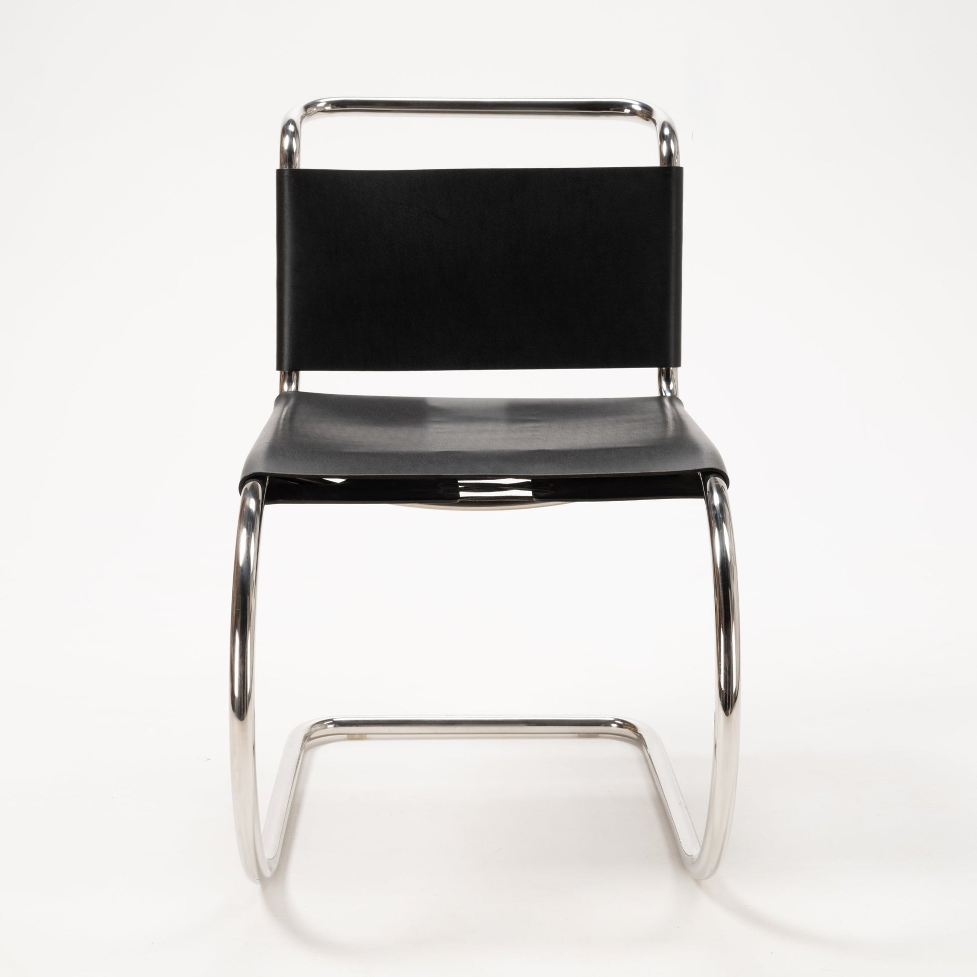 Single Van Der Rohe MR10 cantilever chair featuring polished chrome tubular frame and black leather seat and backrest