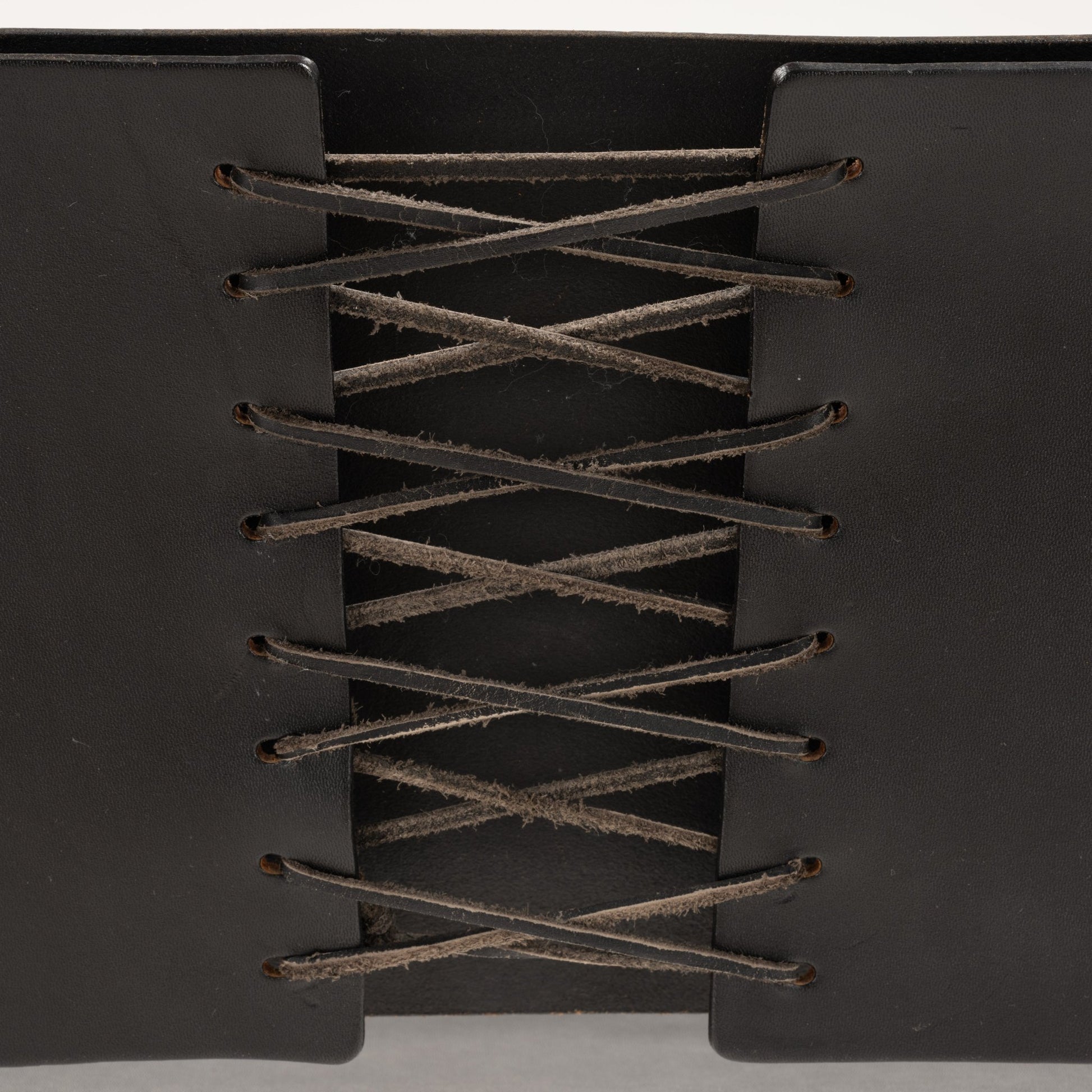Close-up of black leather backrest with intricate lacing detail on Van Der Rohe MR10 cantilever chair