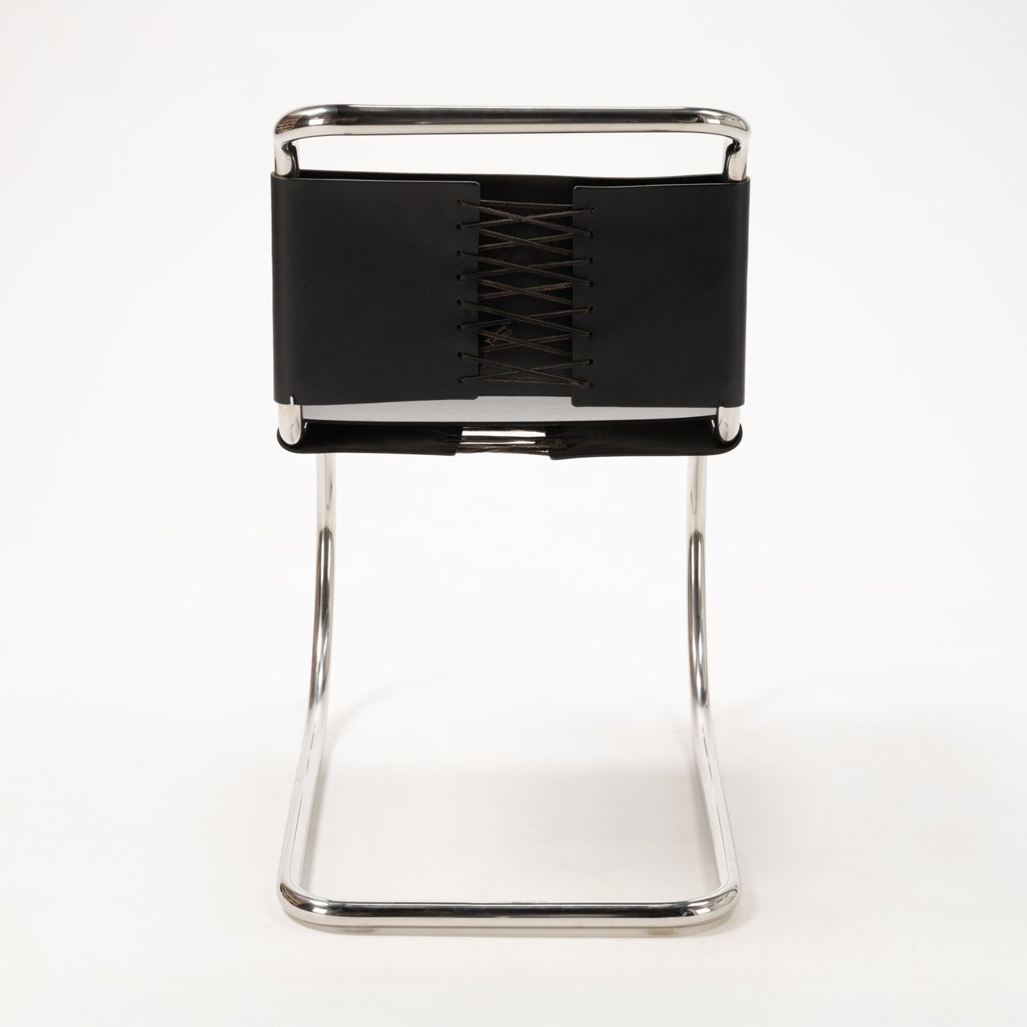 Front view of a Van Der Rohe MR10 cantilever chair with polished chrome tubular frame and black leather laced backrest