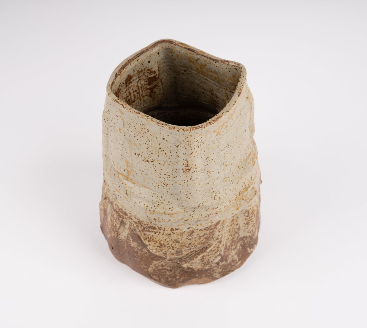 Wabi-Sabi inspired studio pottery vase with organic form, textured beige and brown glaze, and irregular handcrafted silhouette
