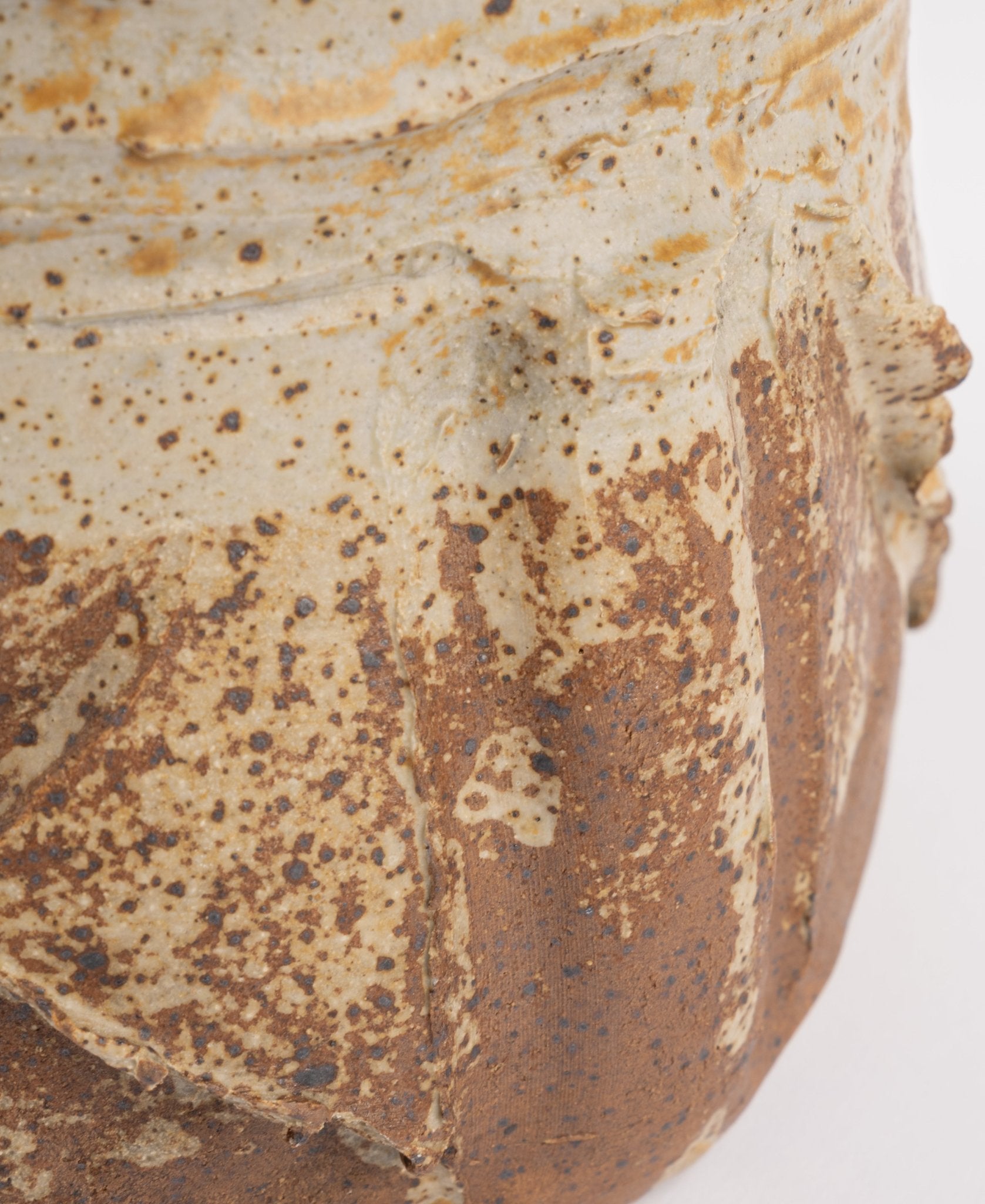 Close-up of Wabi-Sabi inspired ceramic vase with textured earthy glaze and natural speckled brown and beige finish