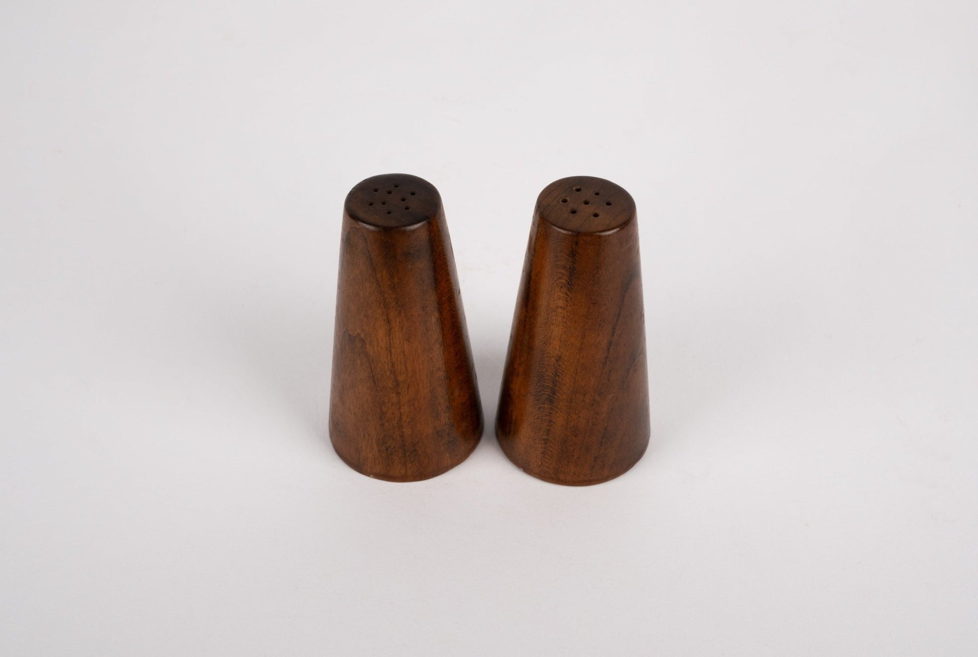 Pair of solid walnut tapered salt and pepper shakers in the style of Paul Evans and Phil Powell