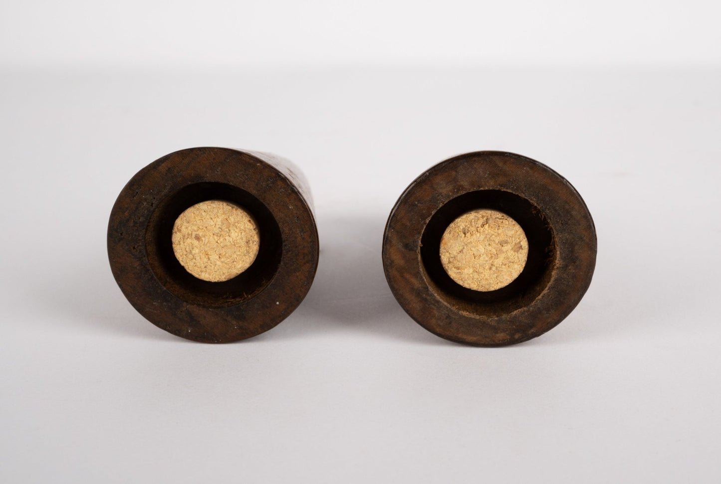Pair of tapered solid walnut salt and pepper shakers with cork stoppers, inspired by Paul Evans and Phil Powell design.