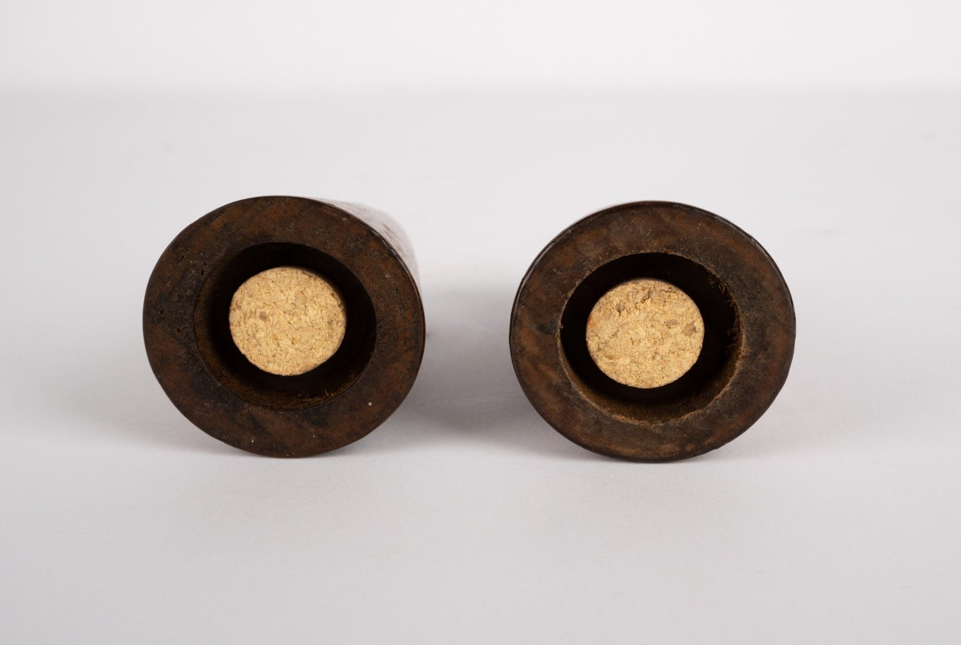 Pair of tapered solid walnut salt and pepper shakers with cork stoppers, inspired by Paul Evans and Phil Powell design.