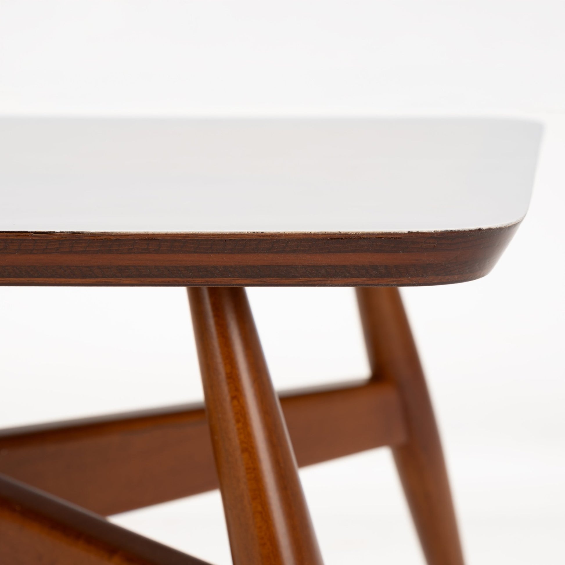 Walnut Side Table with Laminate Top featuring a crisp white surface with softly rounded edges and warm walnut wood legs joined by sturdy angular supports, reflecting mid century modern style.