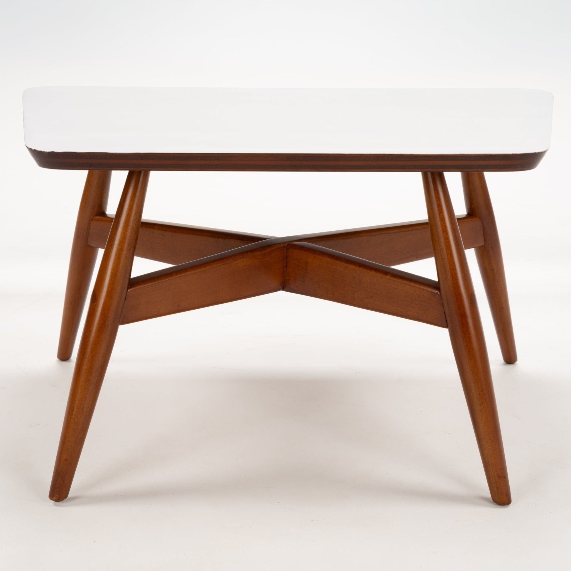 Walnut Side Table with Laminate Top featuring a white surface supported by elegantly tapered walnut legs joined with an intersecting X-shaped frame, inspired by mid century modern style.