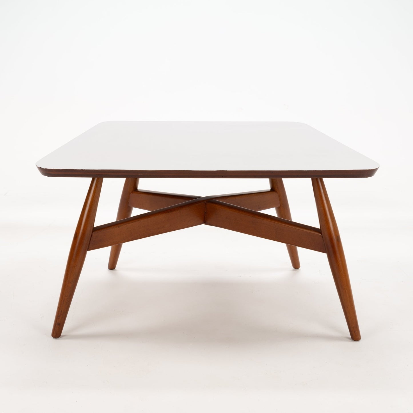 Walnut Side Table with Laminate Top featuring a smooth white surface supported by elegantly angled walnut legs connected with a distinctive crossed wood brace, showcasing mid century modern design.