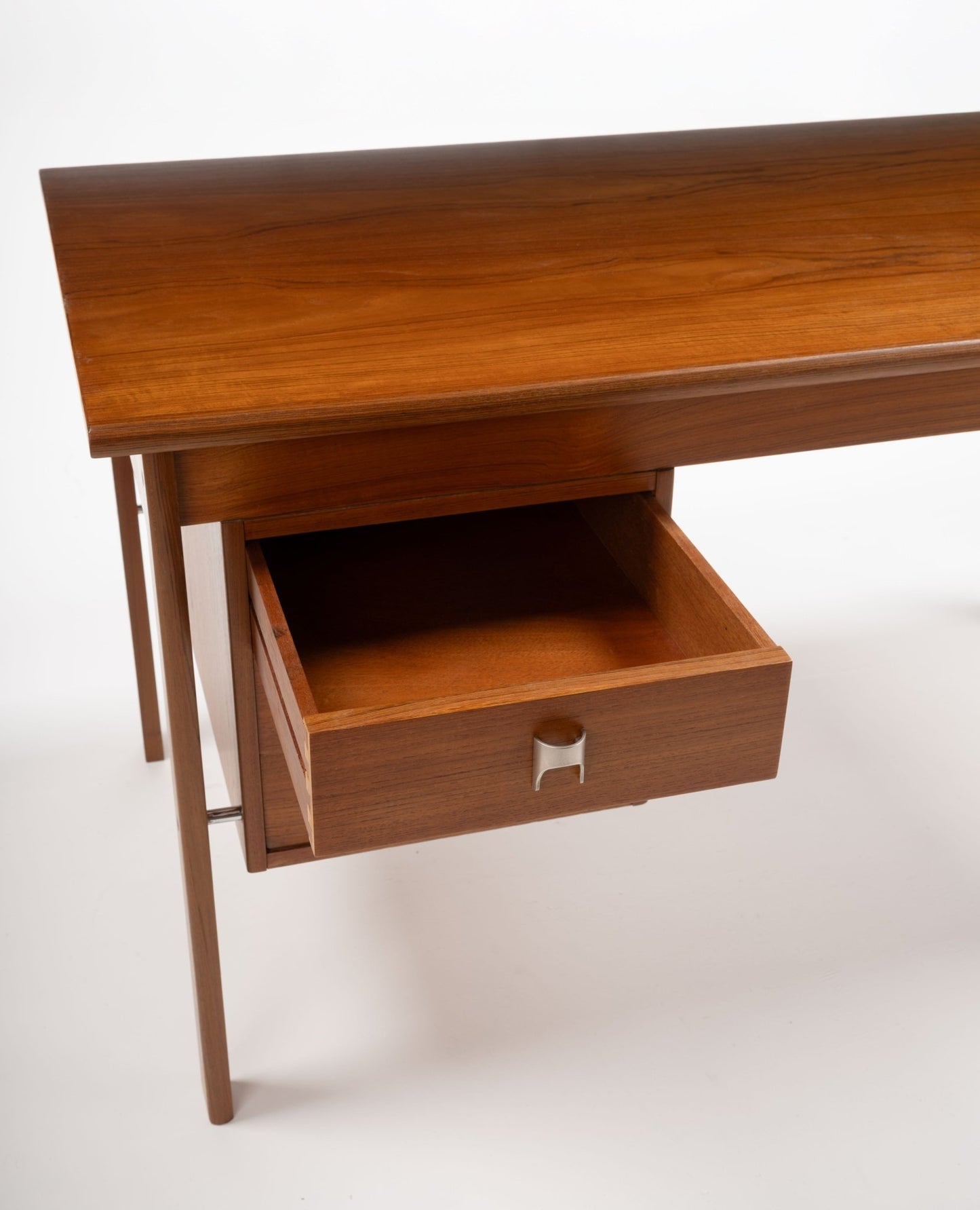 Mid-century modern teak writing desk by Peter Lovig Nielsen with open drawer and sleek stainless steel handle